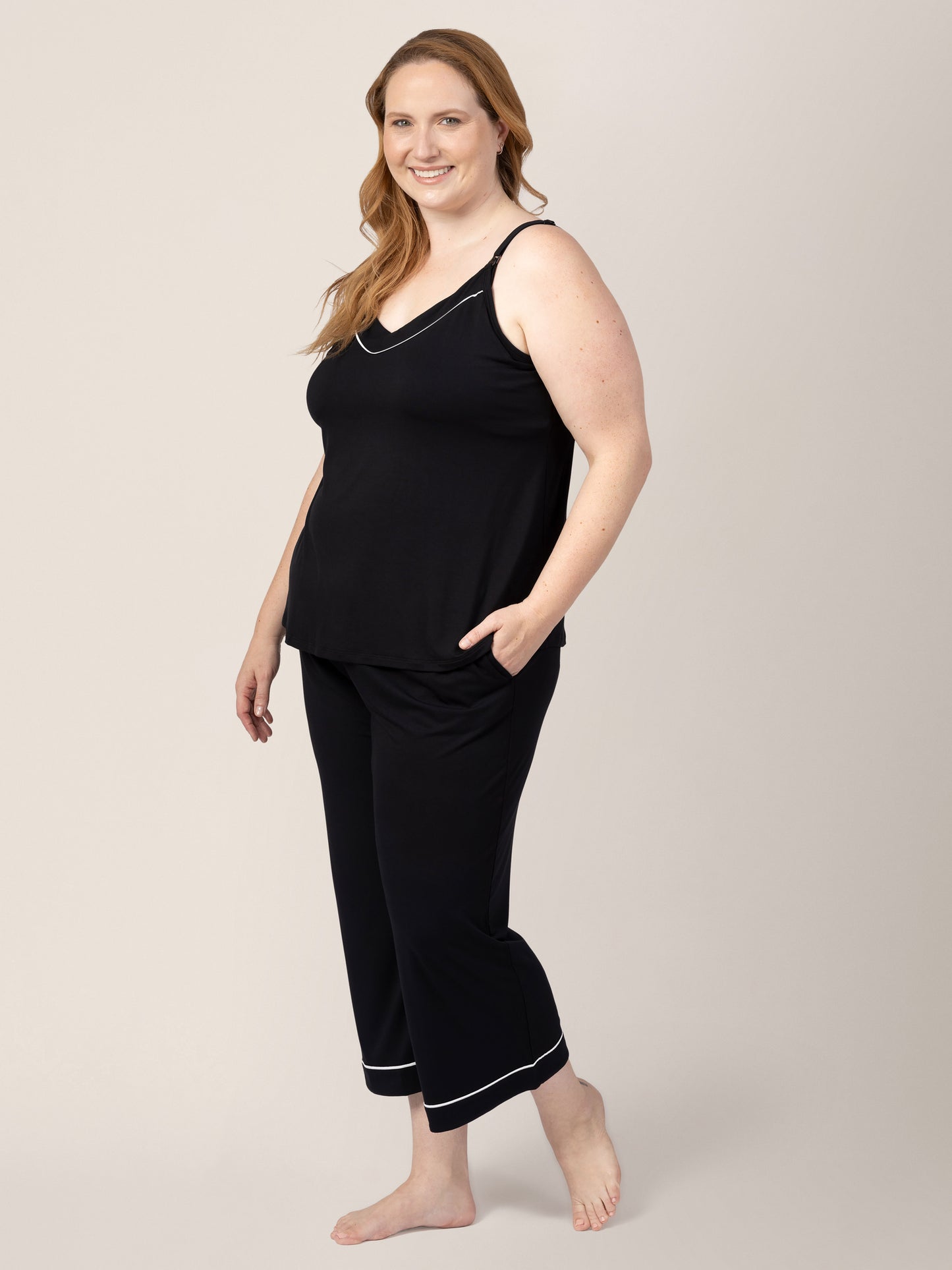 Side view of model wearing Clea Bamboo Nursing Tank & Capri Pajama Set in Black, with hand in pocket