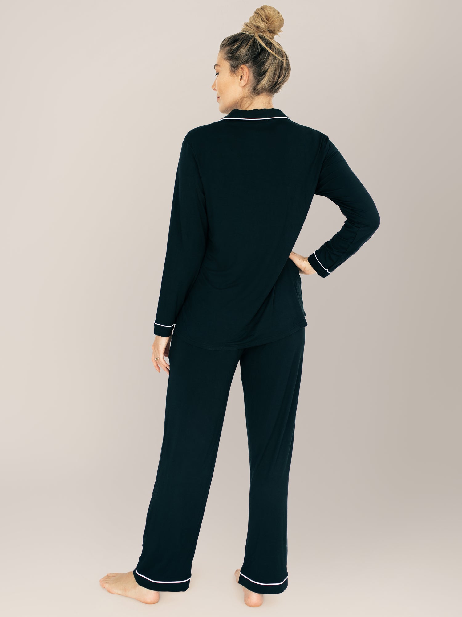 Back view of a model wearing the Clea Bamboo Long Sleeve Pajama Set in Black