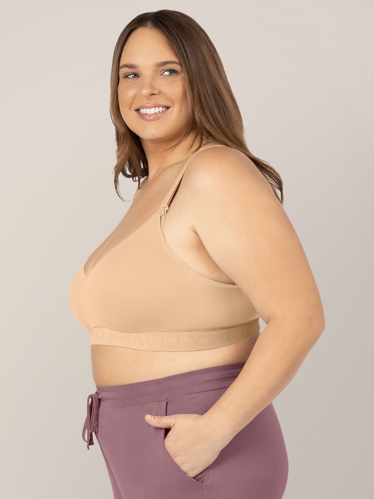 Model wearing the Signature Sublime® Contour Maternity & Nursing Bra in Beige with her hands in her pockets.