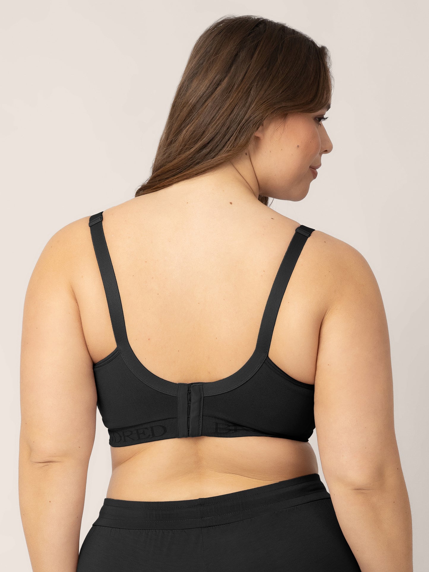 Back of a busty model wearing the Signature Sublime® Contour Maternity & Nursing Bra in Black