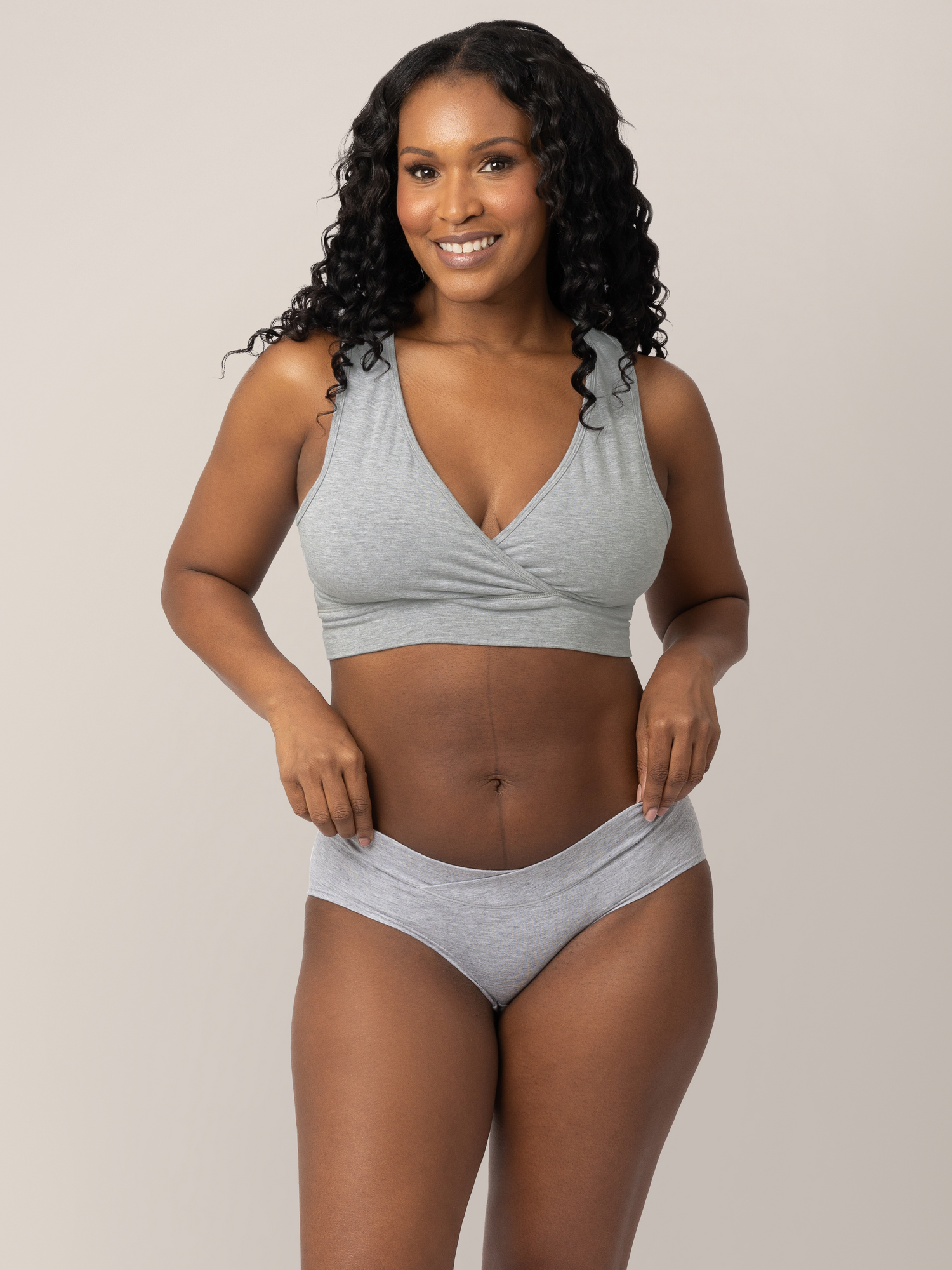 Model wearing the  Bamboo Maternity & Postpartum Hipster in Grey Heather with her hands on her hips. @model_info:Rashé is wearing a Medium.