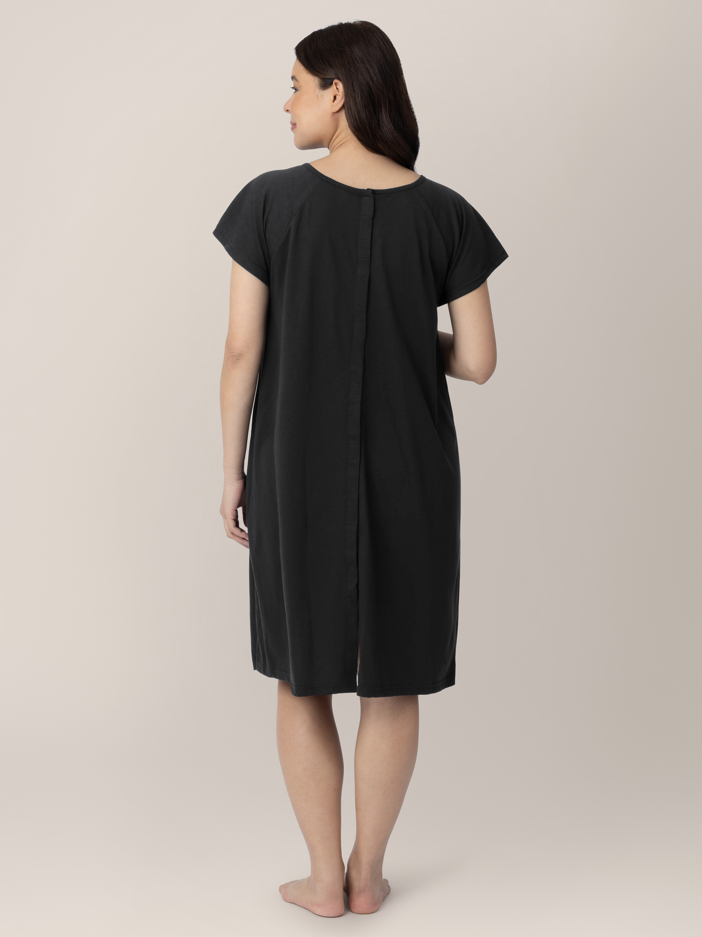 Back view of a pregnant model wearing the Universal Labor & Delivery Gown in Black