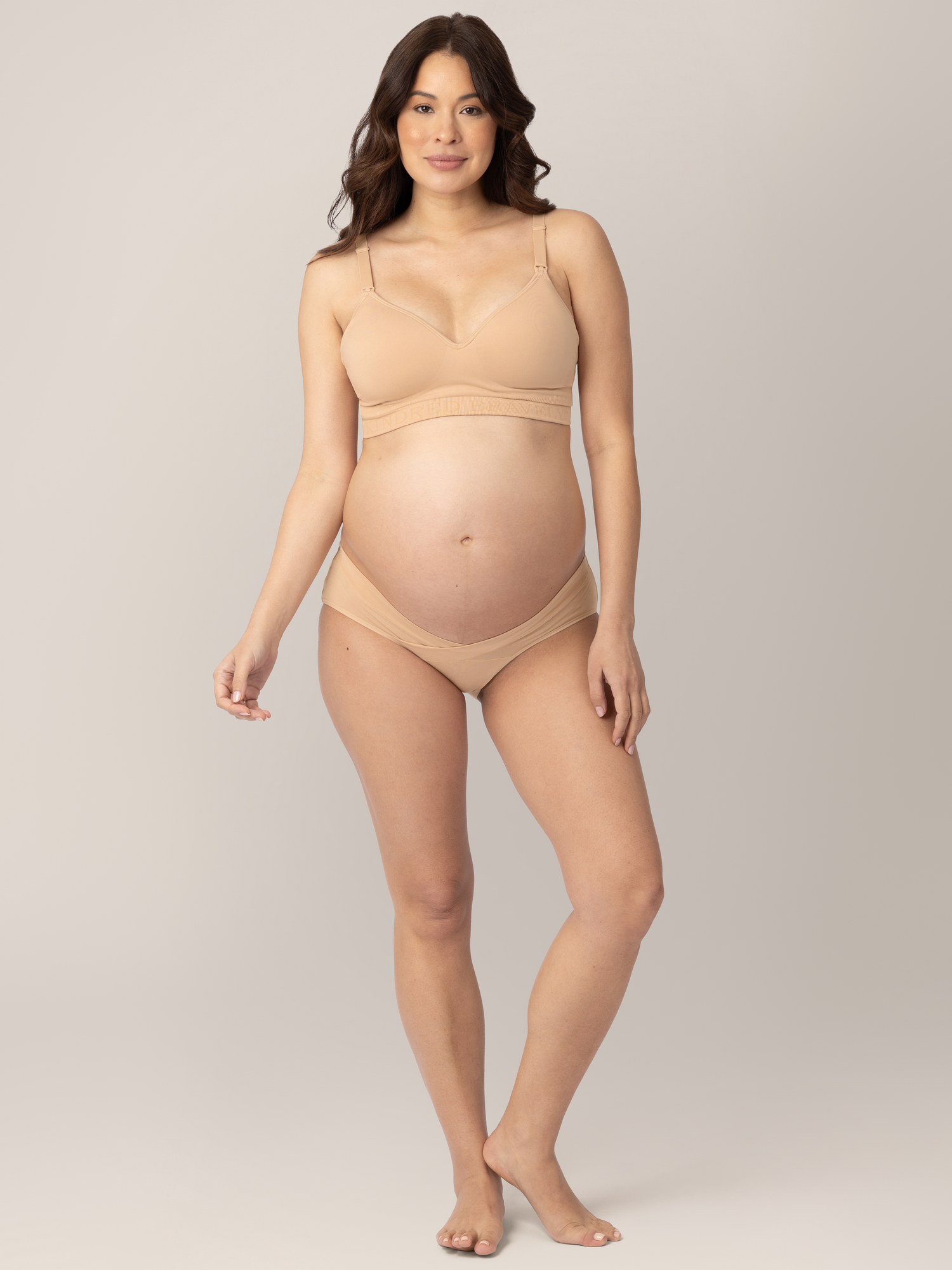 Front view of a pregnant model wearing the Under-the-Bump Bikini Underwear in Neutrals