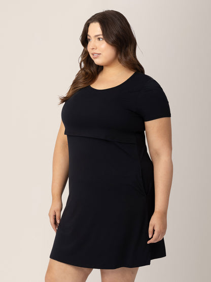 Three-Quarters view of a model wearing the Eleanora Bamboo Maternity & Nursing Dress in Black. 