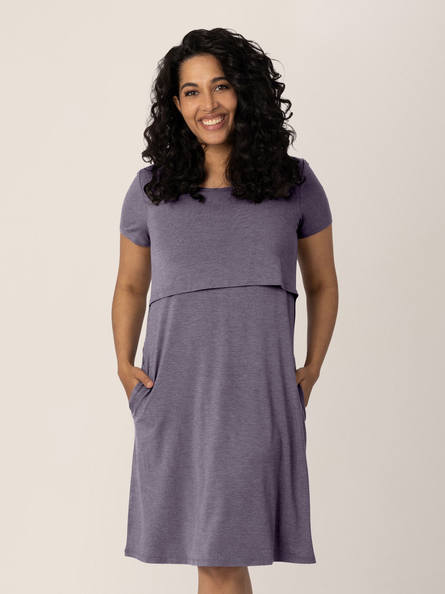 Model wearing the Eleanora Bamboo Maternity & Nursing Dress in Heathered Granite with her hands in her pocket. @model_info:Zakeeya is wearing a Small.