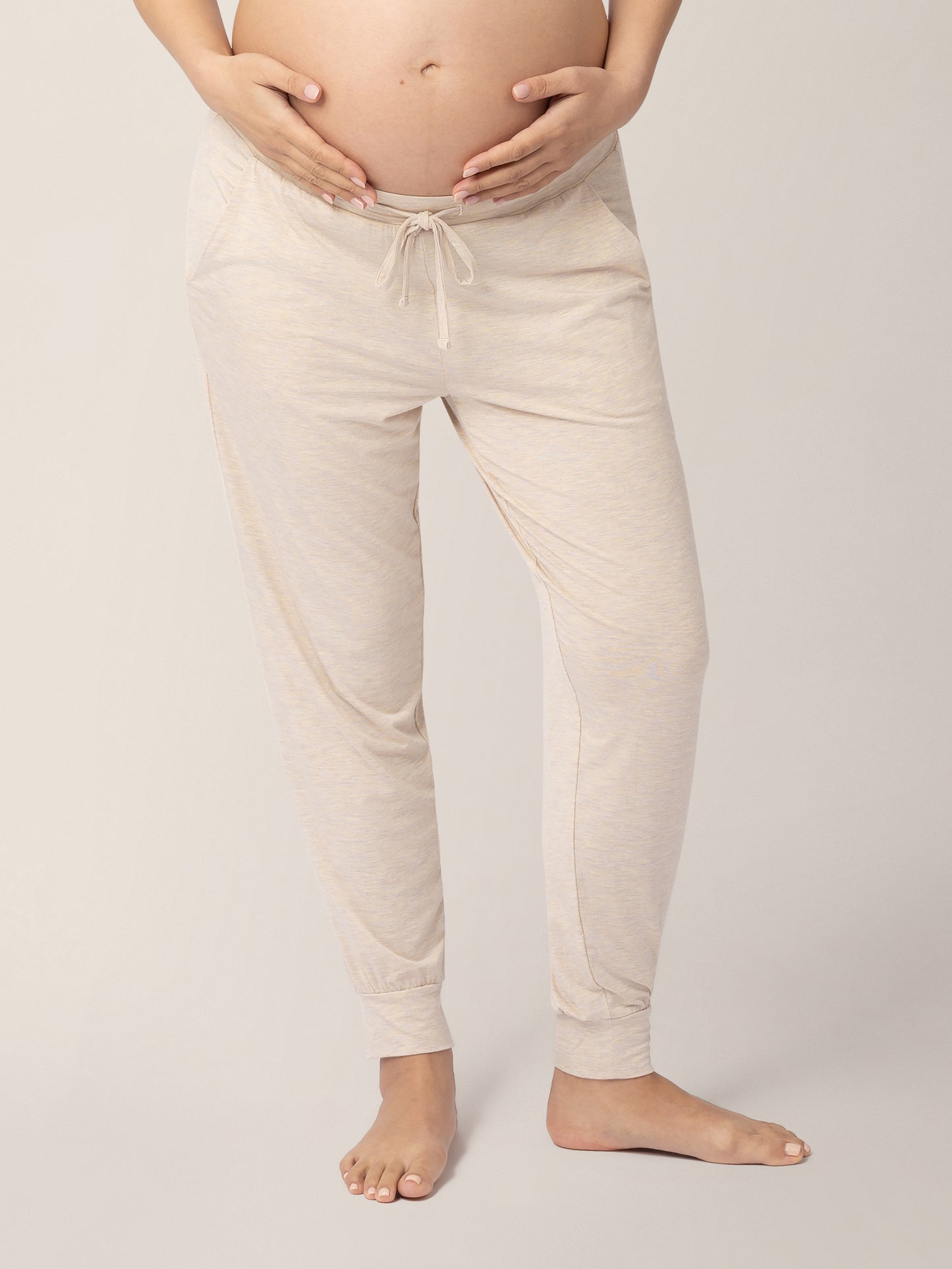 Front of a pregnant model wearing the Everyday Lounge Jogger in Oatmeal Heather