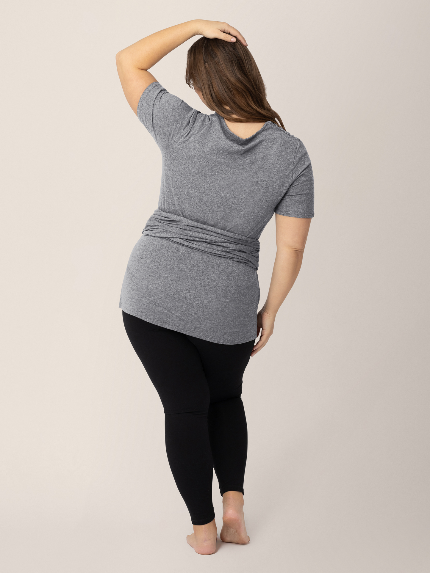 Back view of a model wearing the Organic Cotton Skin to Skin Wrap Top in Charcoal Grey Heather