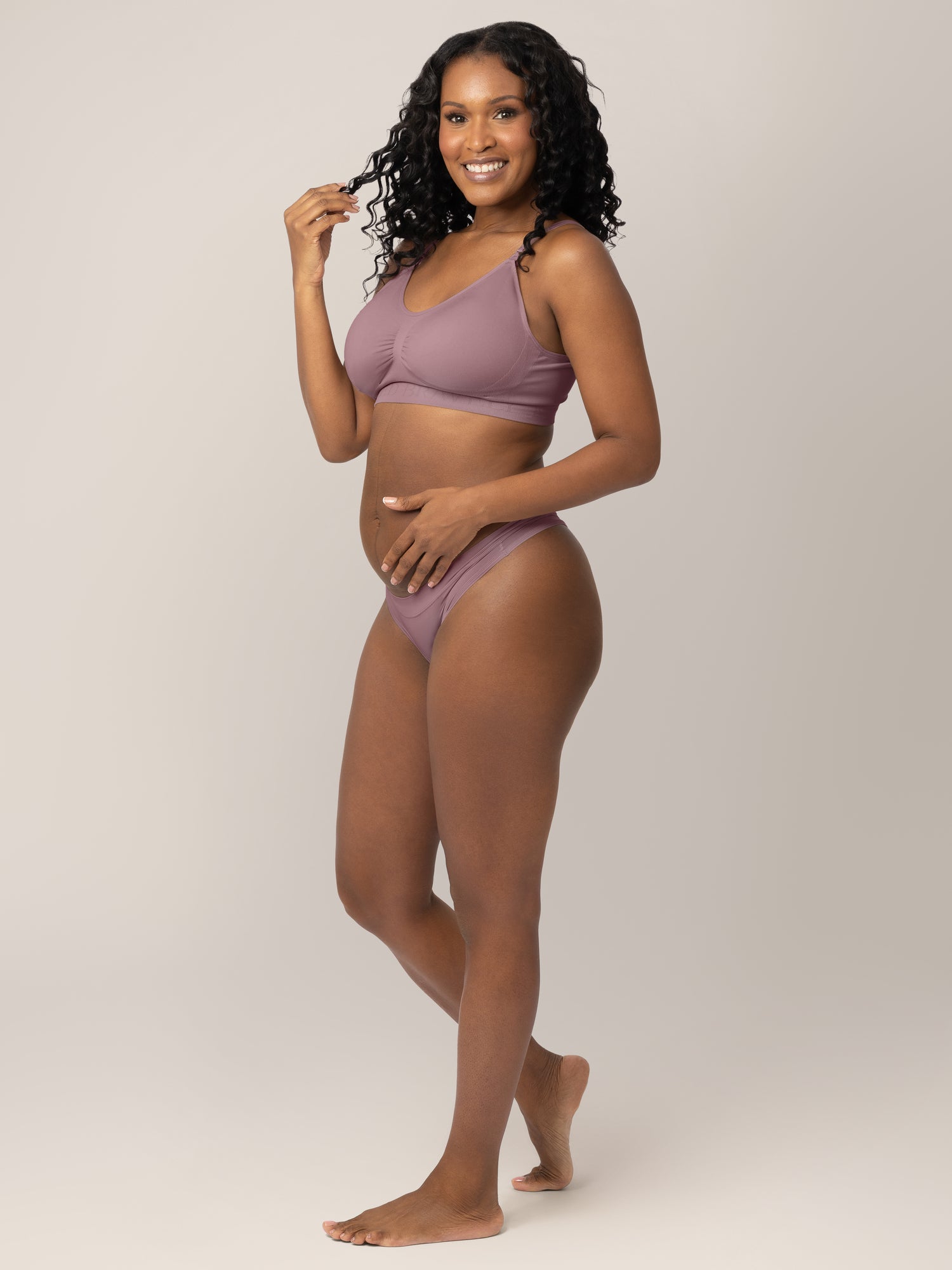 Model wearing the Grow with Me™ Maternity & Postpartum Thong in Twilight with her hands in her hair.