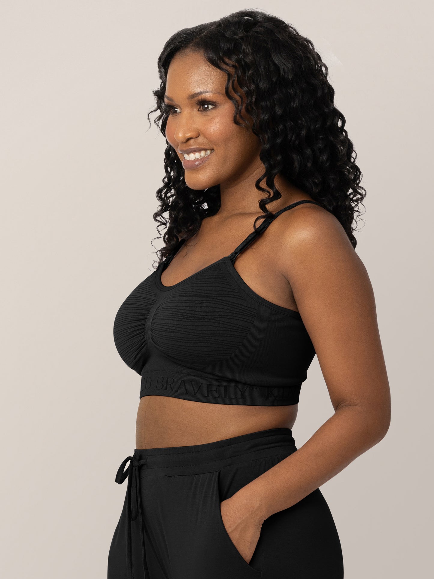 Three-quarters shot of a model wearing the Sublime® Hands-Free Pumping & Nursing Bra in Black