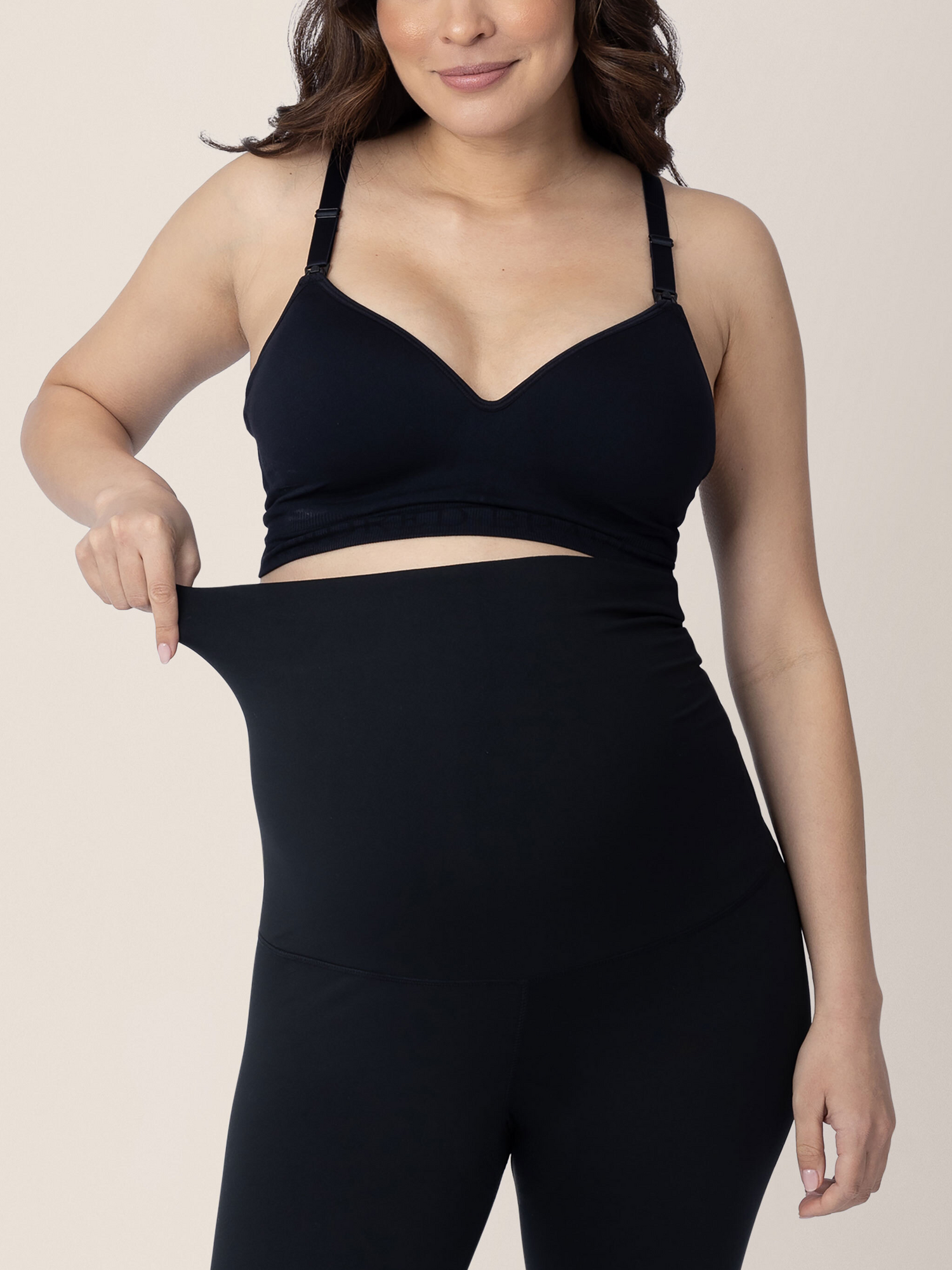 Model showing the stretchy waistband on the classic Louisa Maternity & Postpartum Legging in Black.