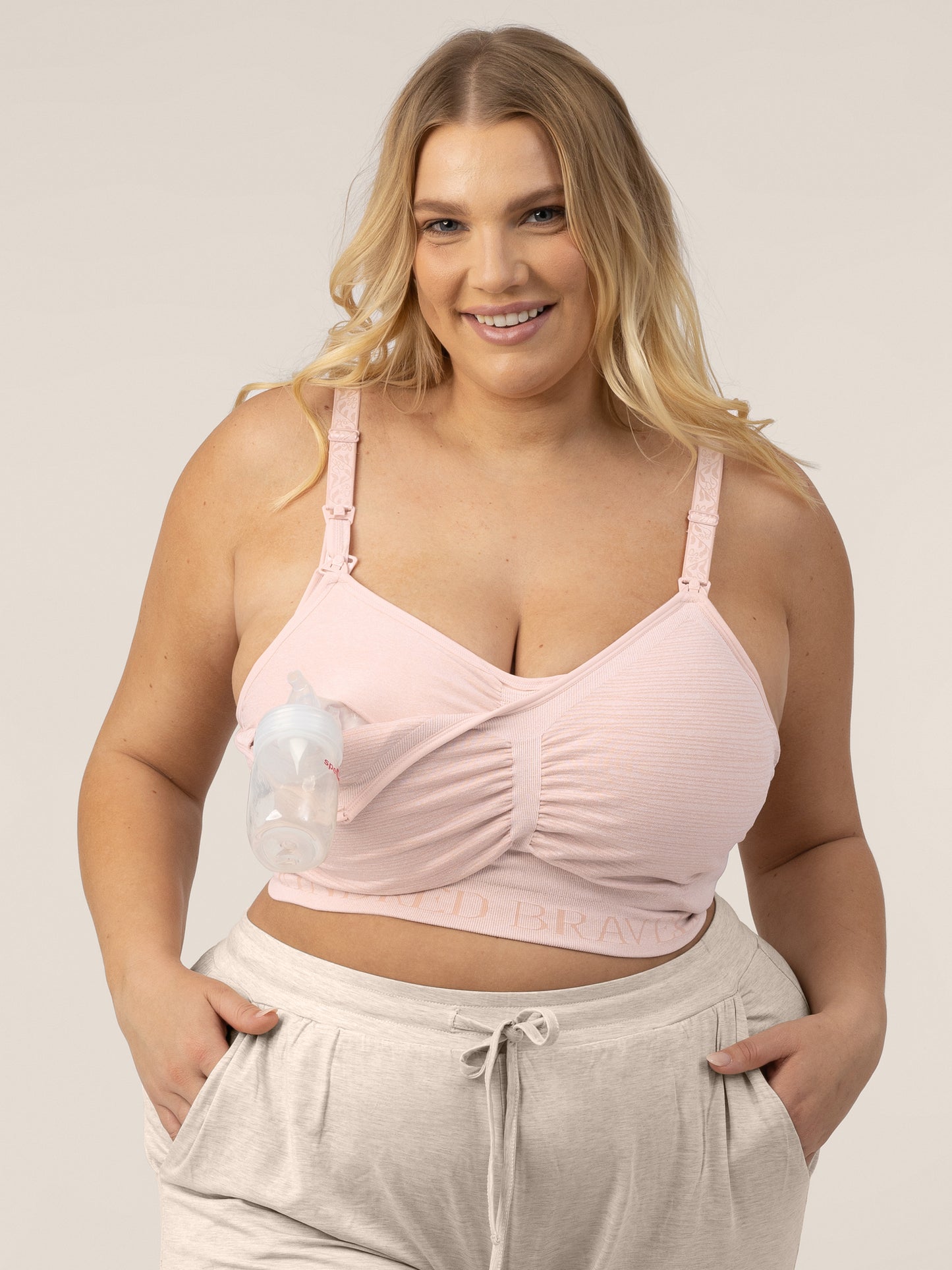 Busty model wearing the Sublime® Hands-Free Pumping & Nursing Bra in Pink Heather @model_info:Lauren is wearing an X-Large Busty.