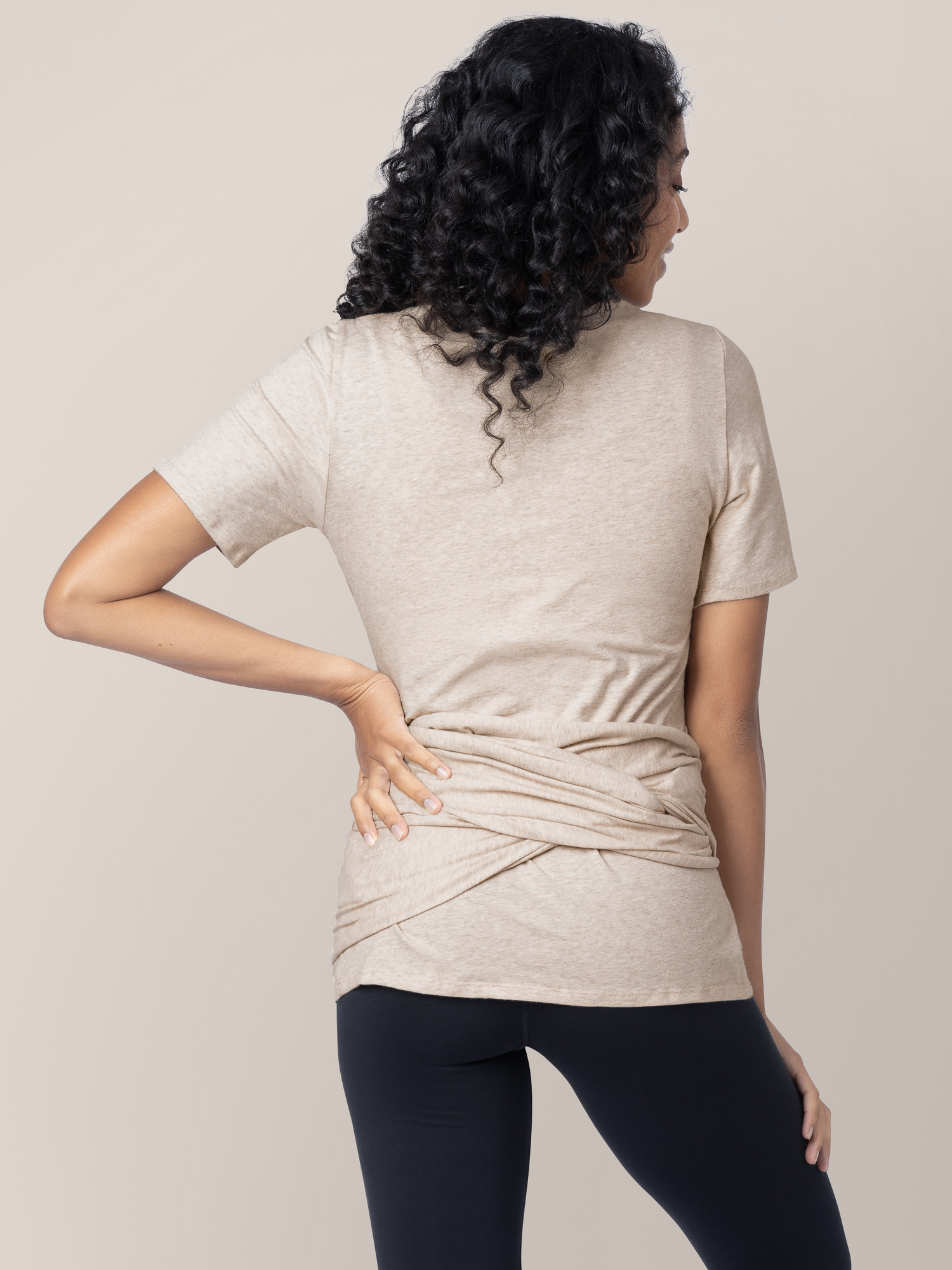 Back of a model wearing the Organic Cotton Skin to Skin Wrap Top in Oatmeal Heather