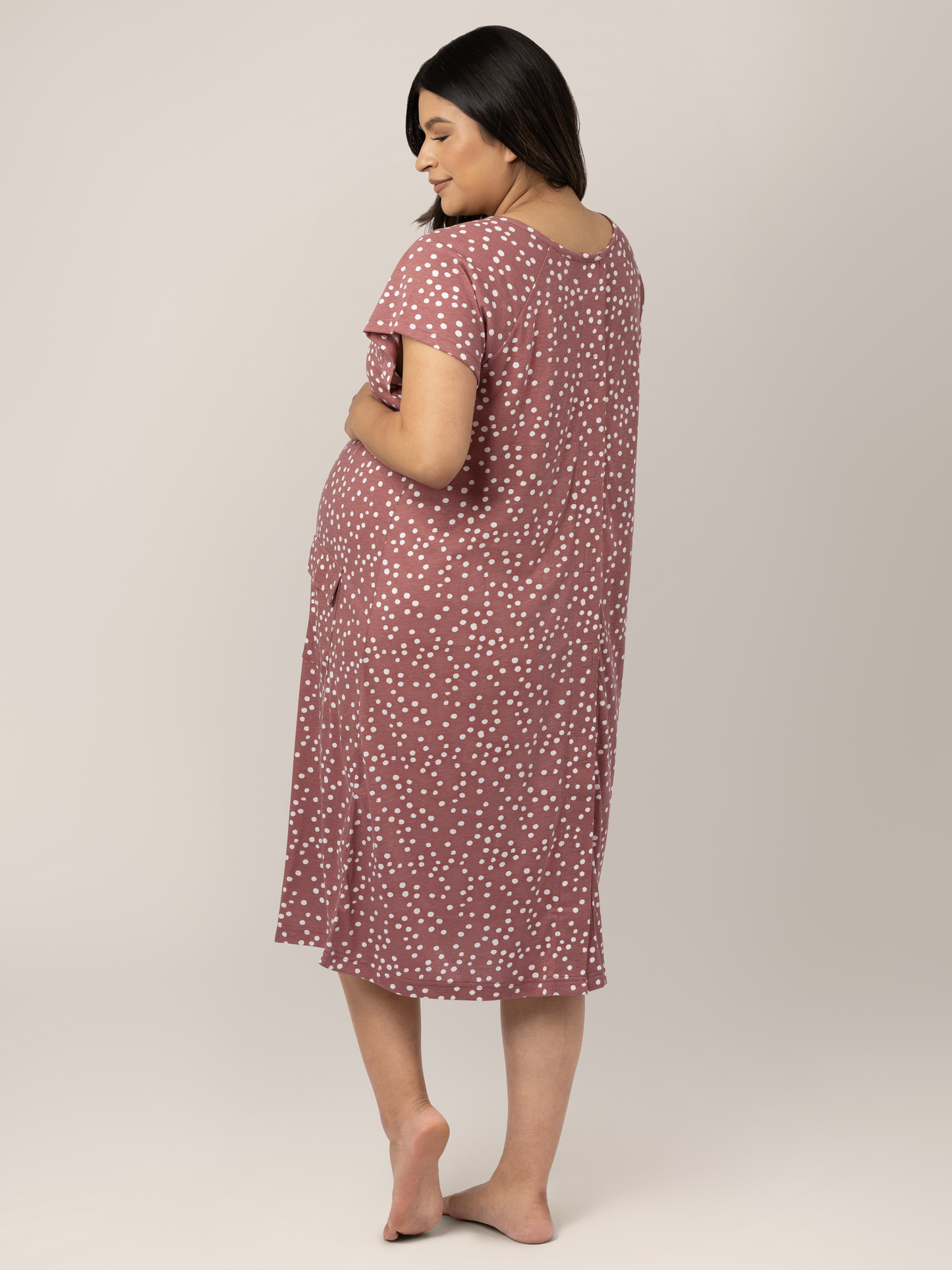 Back view of a pregnant model wearing the Universal Labor & Delivery Gown in Rosewood Polka Dot