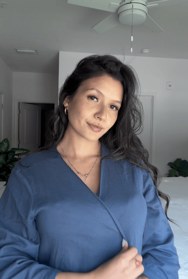 Rotating gif of pregnant model tying belt of Cotton Bamboo Robe in Midnight Blue in bedroom.