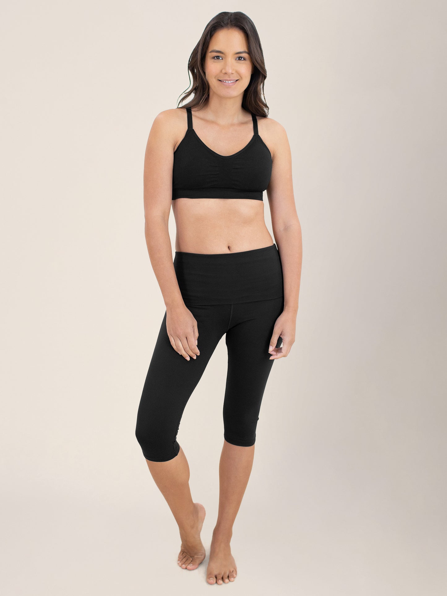 Model standing with her weight more on one leg with her hands at her sides wearing the Diana Sublime® Sports Bra in Black@model_info:Cristy is wearing a Small. 