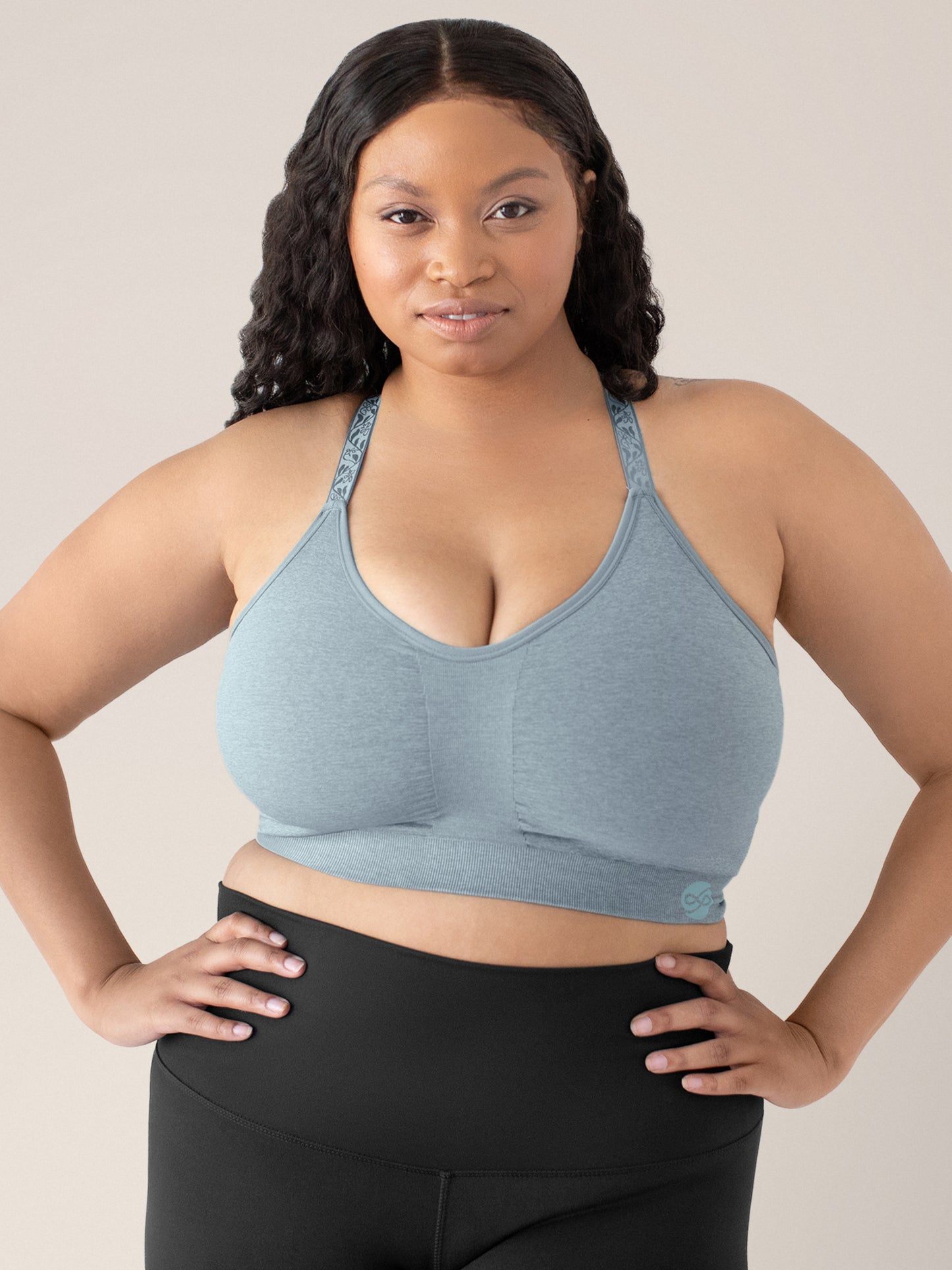 Model with her hands on her hips wearing the Diana Sublime® Sports Bra in Seaglass Heather