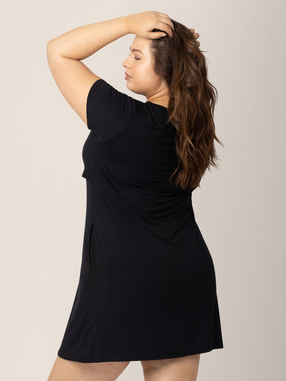 Model with her hands in her hair wearing the Eleanora Bamboo Maternity & Nursing Dress in Black.