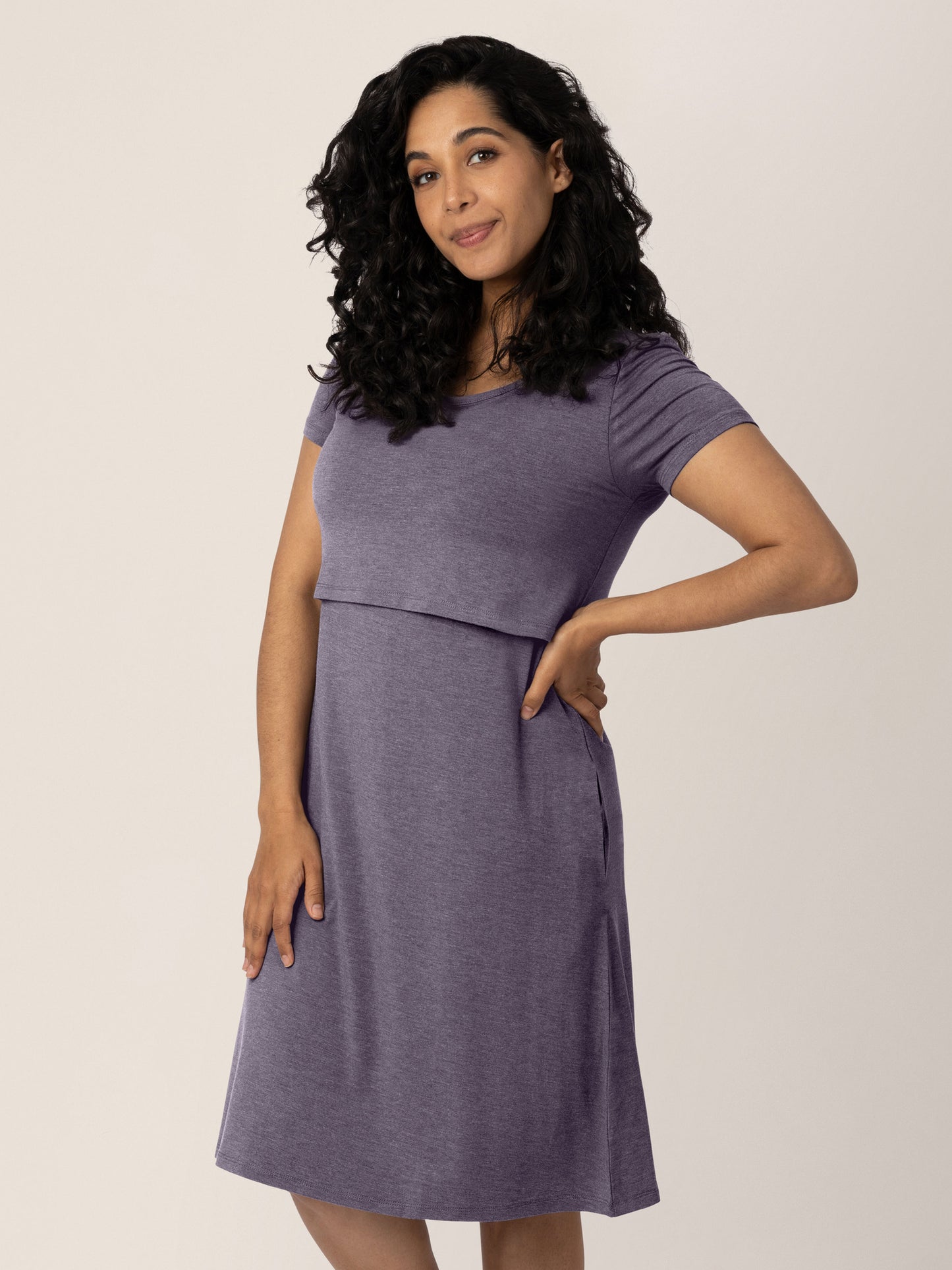 Model wearing the Eleanora Bamboo Maternity & Nursing Dress in Heathered Granite with her hand on her hip.