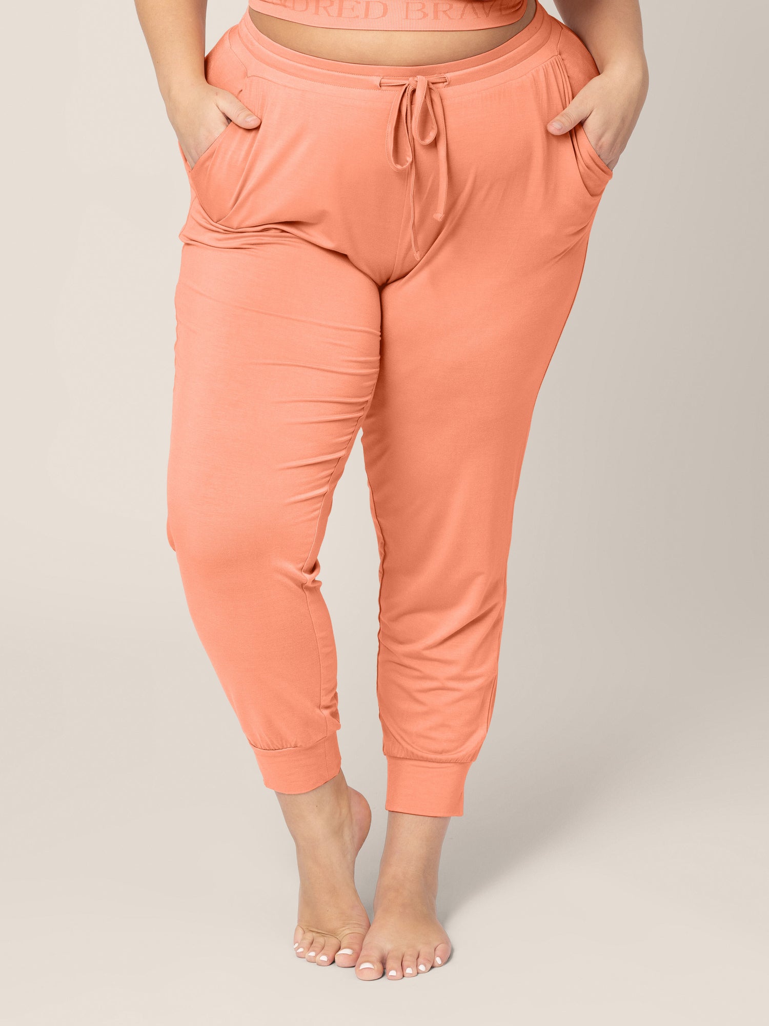 Front view of the bottom half of a model wearing the Everyday Lounge Joggers in Vintage Coral @model_info:Lauren is 5'6" and wearing an X-Large Regular.