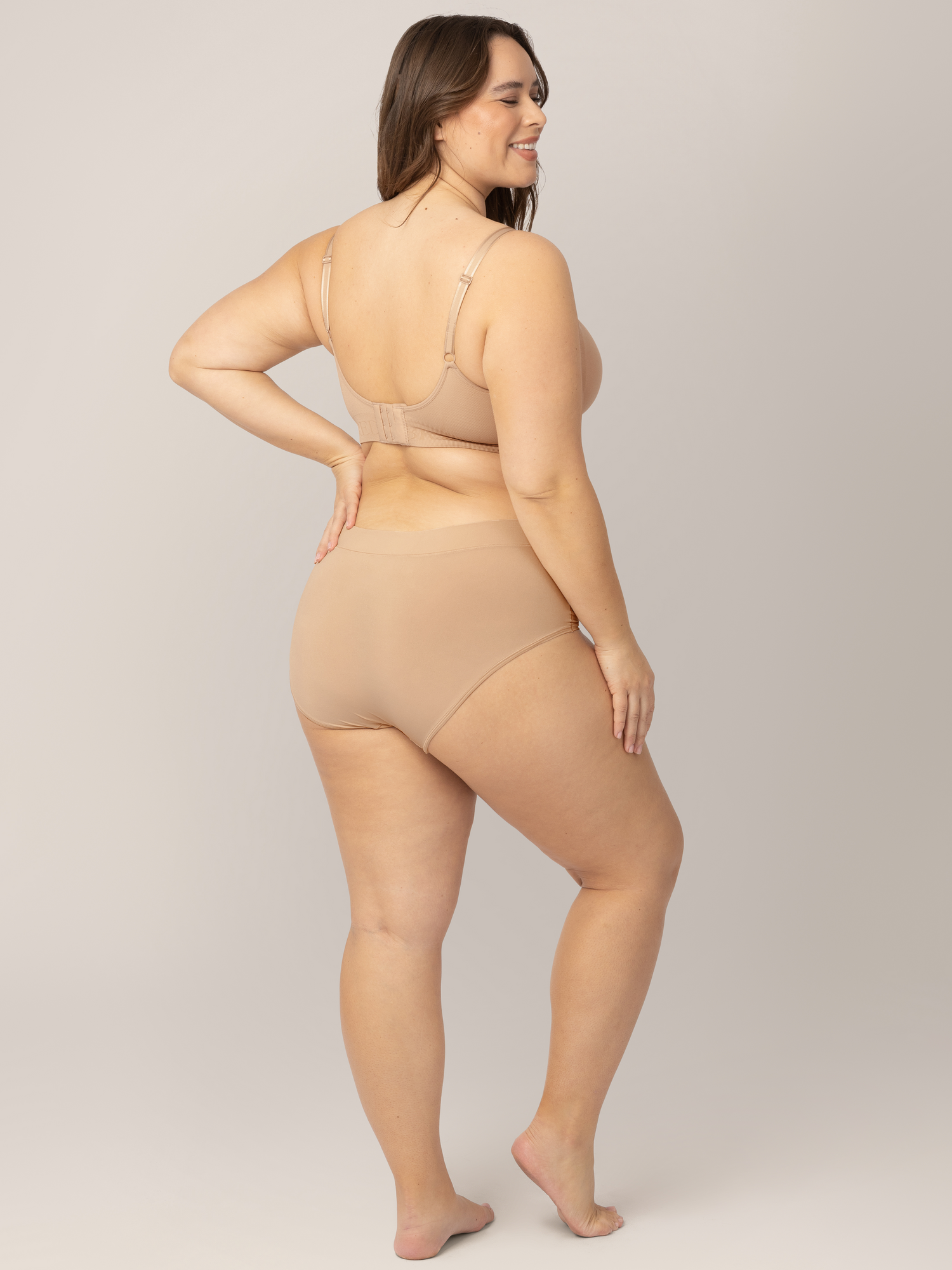 Back of a model wearing the Grow with Me™ Maternity & Postpartum Brief in Beige