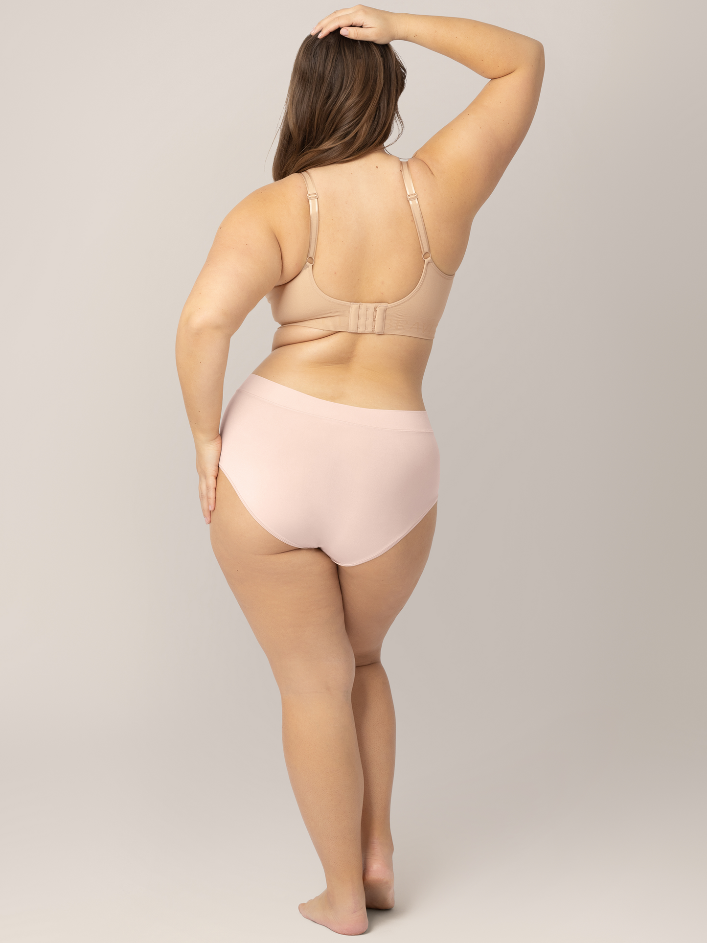Back of a model wearing the Grow with Me™ Maternity & Postpartum Brief in Soft Pink. 