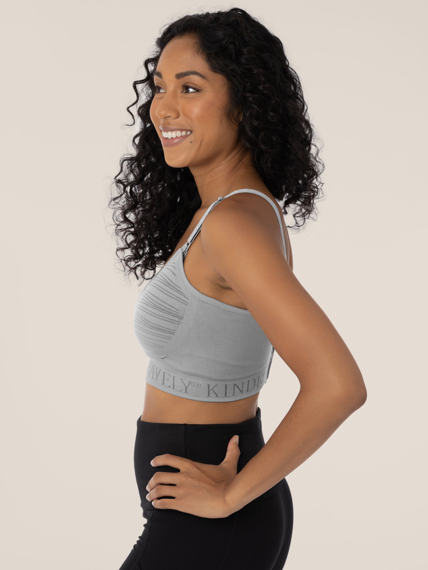 Side view of a model wearing the Sublime® Hands-Free Pumping & Nursing Bra in Grey