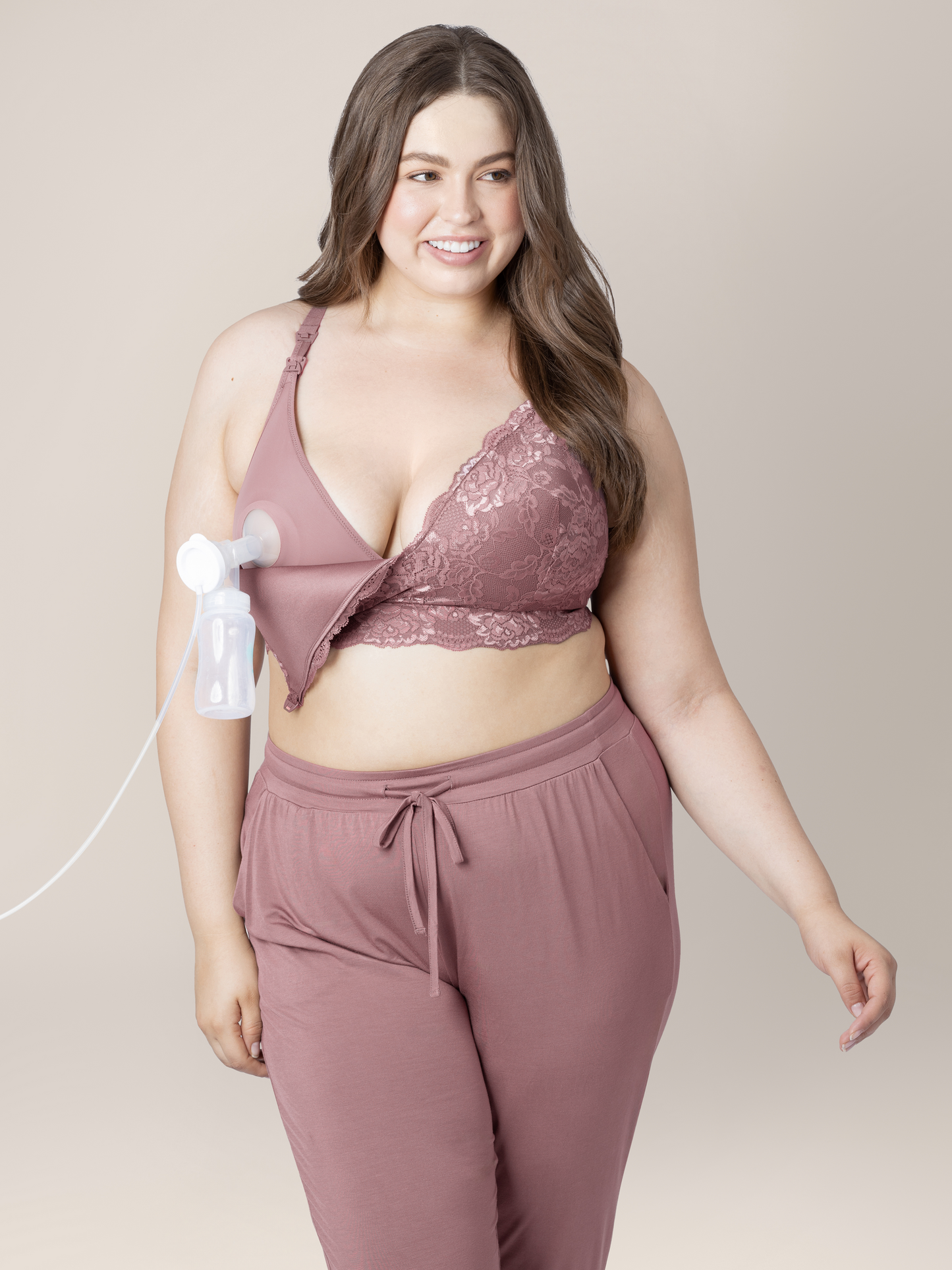 Model wearing the Lace Minimalist Hands-Free Pumping & Nursing Bra in Twilight connected to a pump. 