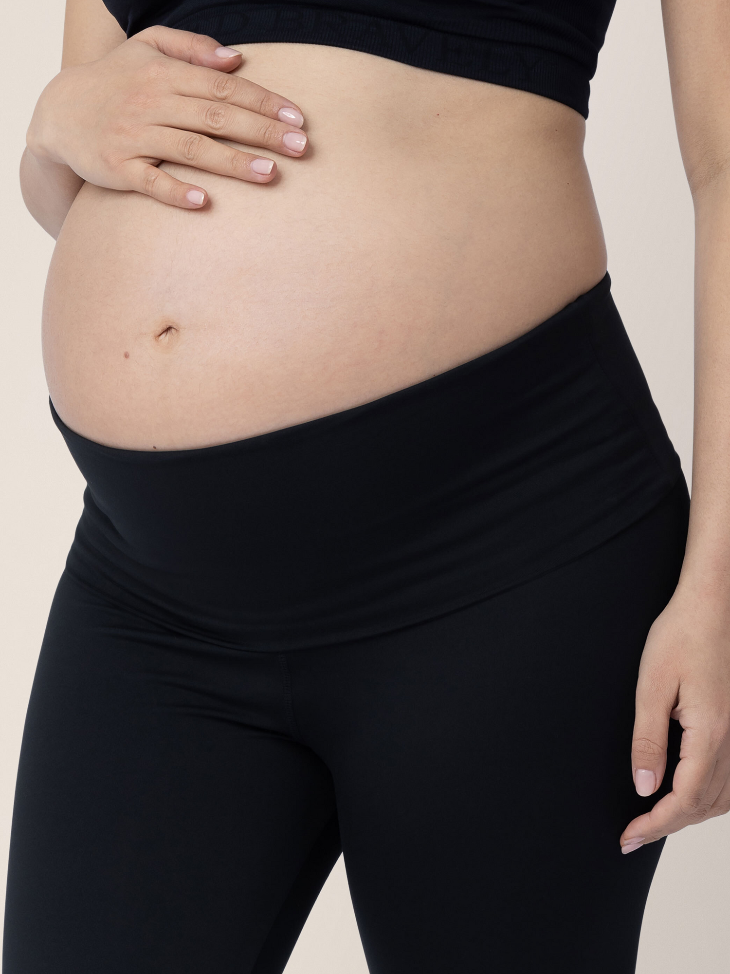 Closeup of a pregnant model wearing the Louisa Maternity & Postpartum Legging in Black, classic.