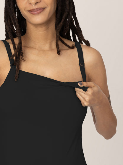 Pregnant model wearing the  Bamboo Lounge Around Nursing Tank in Black and showing the easy clip down nursing access.