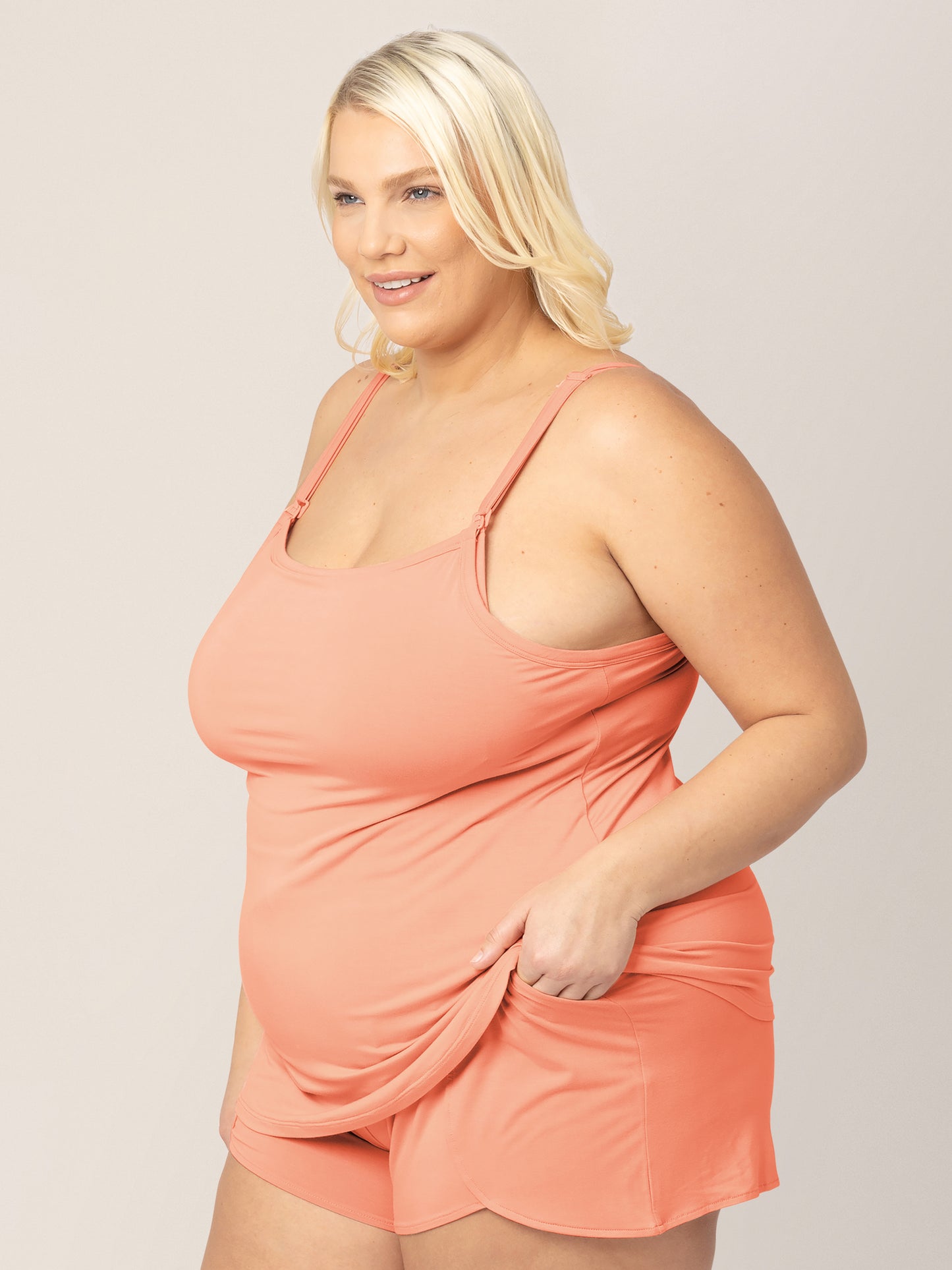 3/4 view of model wearing the Bamboo Lounge Around Nursing & Maternity Tank in vintage coral
