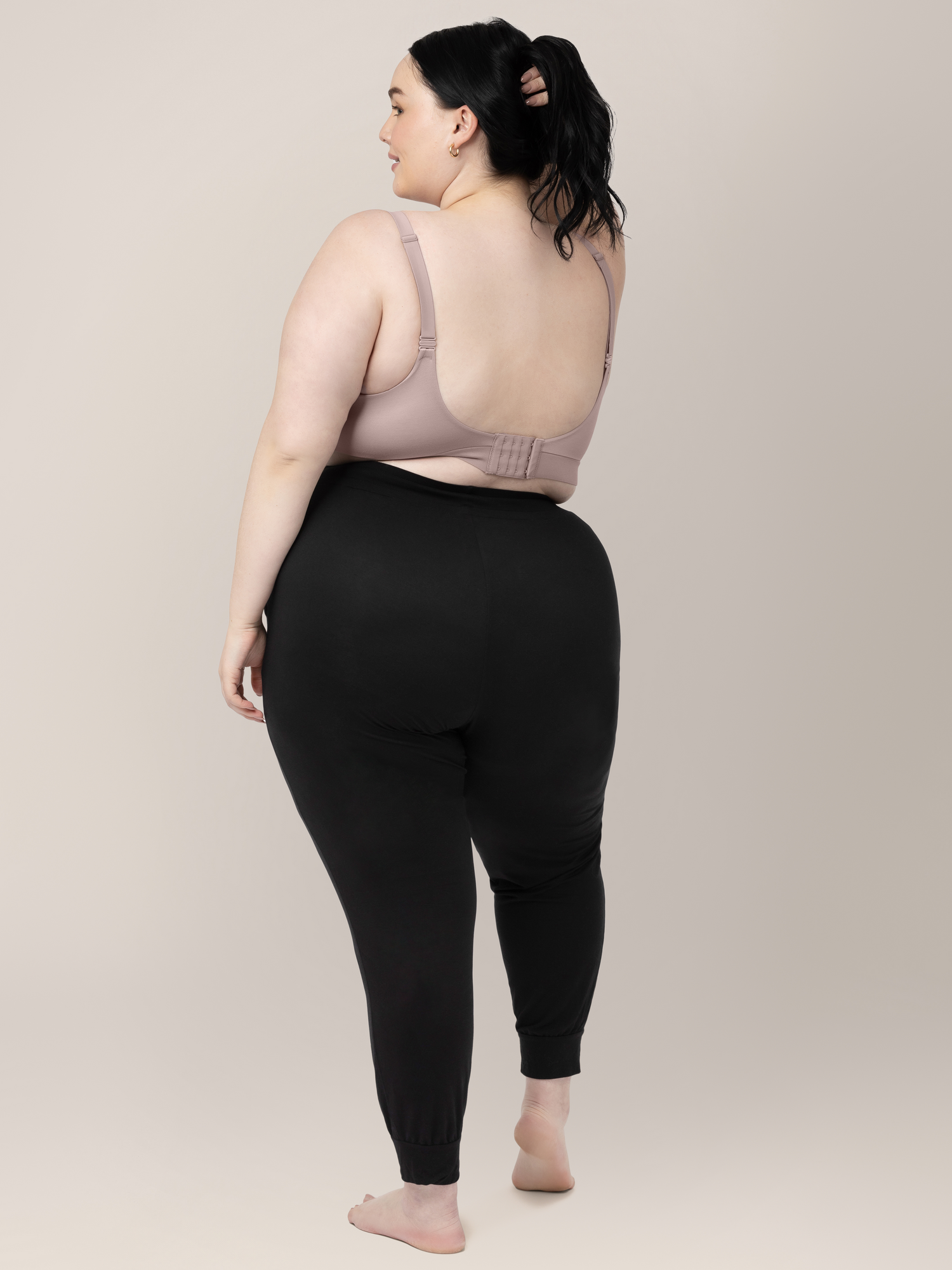 Back of a busty model wearing the Minimalist Maternity & Nursing Bra in Lilac Stone.