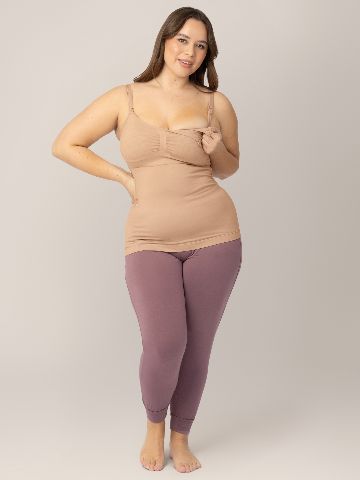 Model showing the clip down nursing access on the Sublime® Hands-Free Pumping & Nursing Tank in Beige