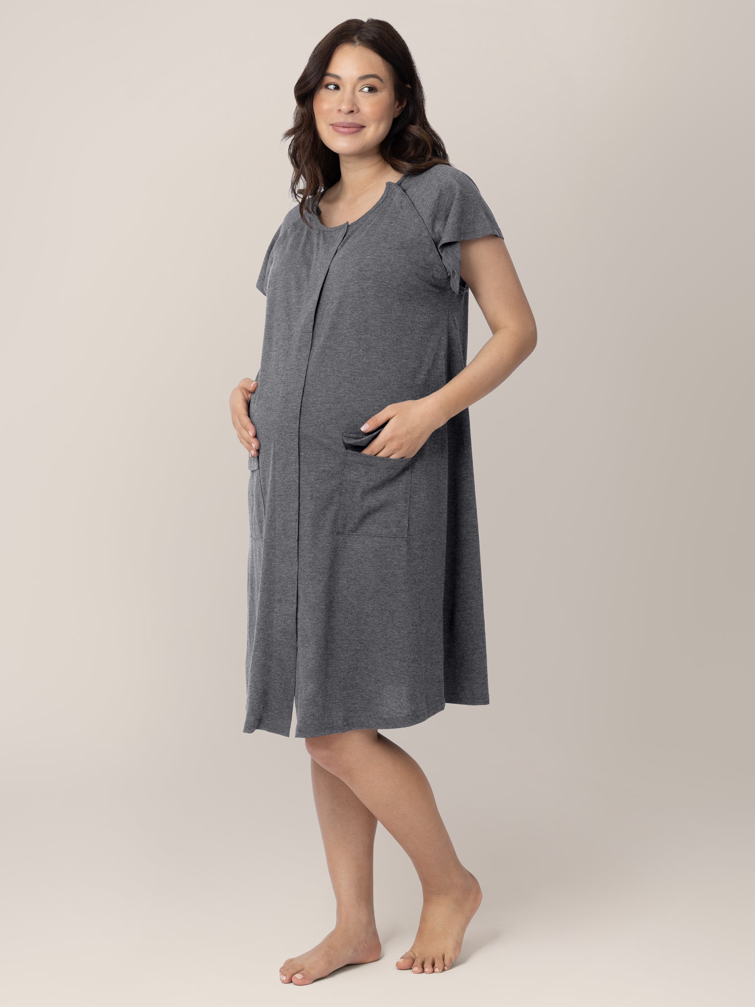 Three quarters view of a pregnant model wearing the Universal Labor & Delivery Gown in Grey Heather
