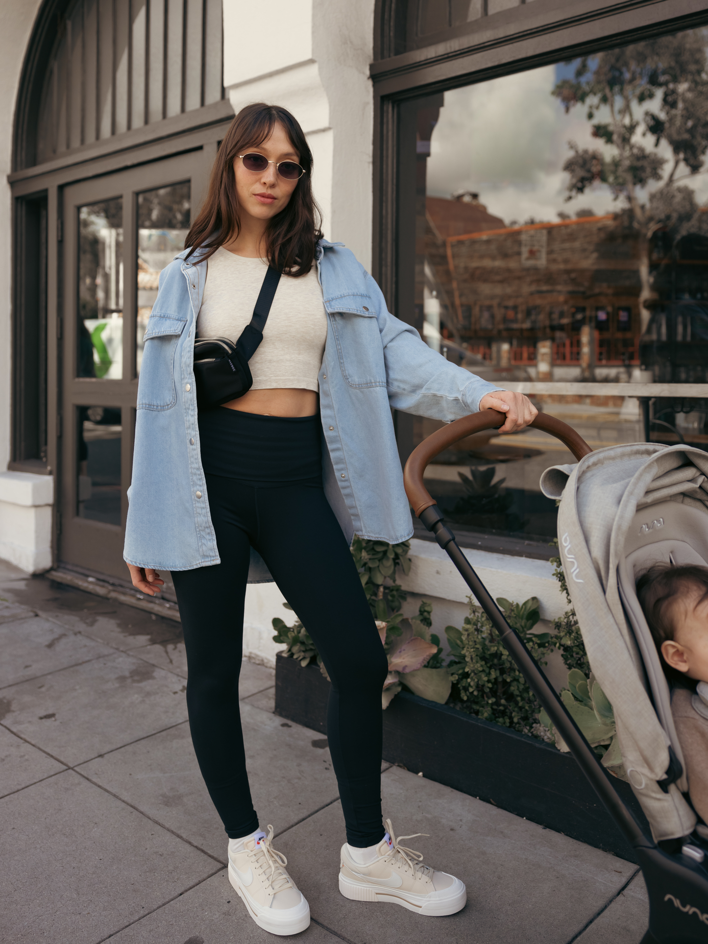 Model outside with stroller and wearing the Sublime Bamboo Maternity & Nursing Longline Bra in Oatmeal Heather, paired with the Louisa Maternity & Postpartum Legging and a denim shacket.