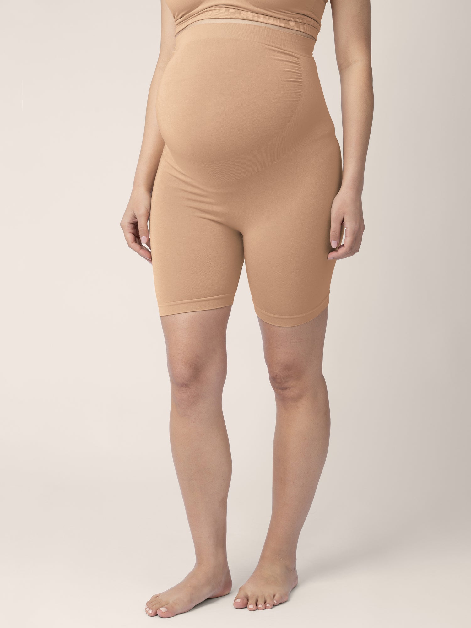 Bottom half of a pregnant model wearing the Seamless Bamboo Maternity Thigh Savers