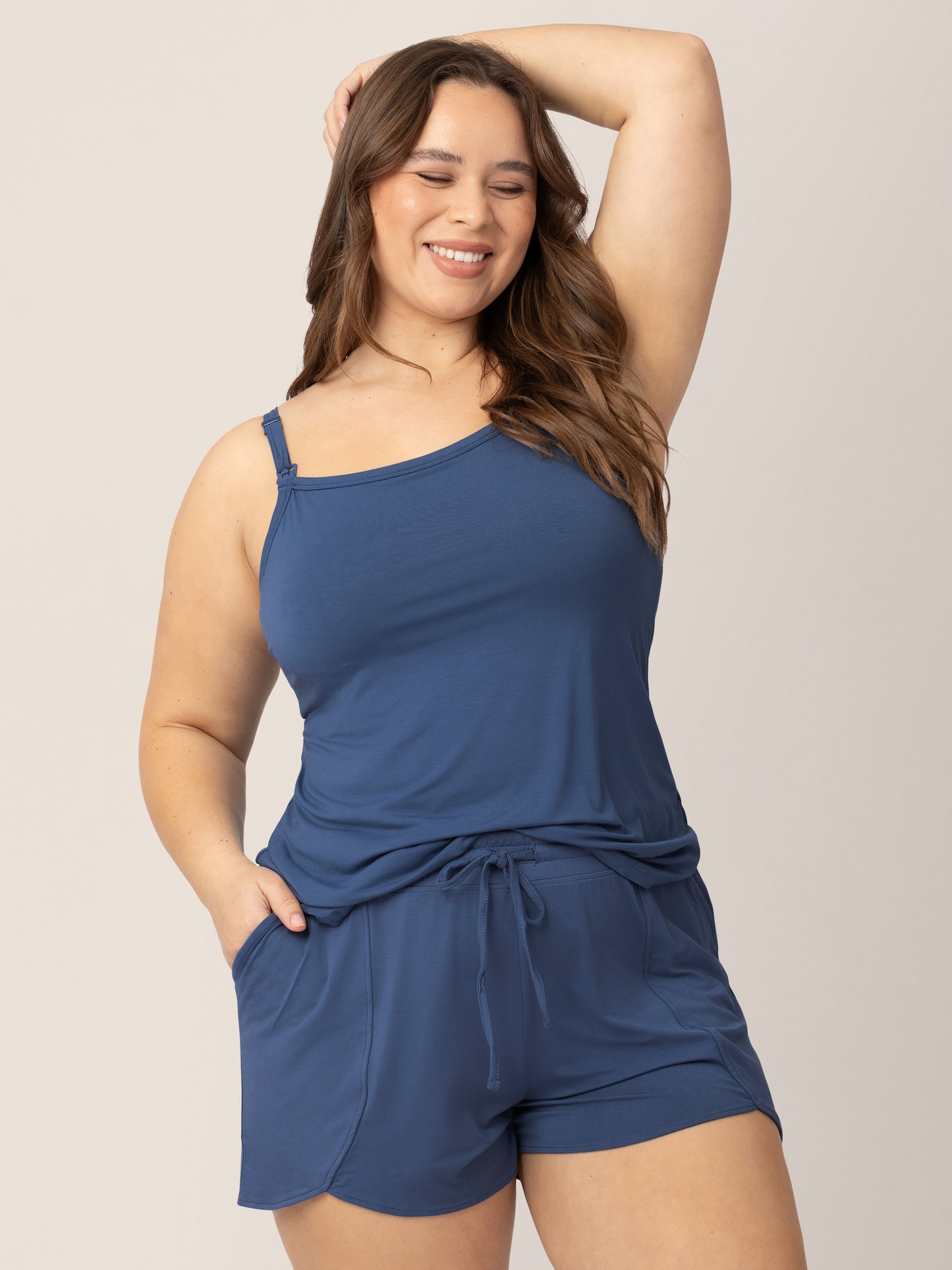 Model with her hand on top of her head wearing the Bamboo Lounge Around Nursing Tank in Slate Blue.