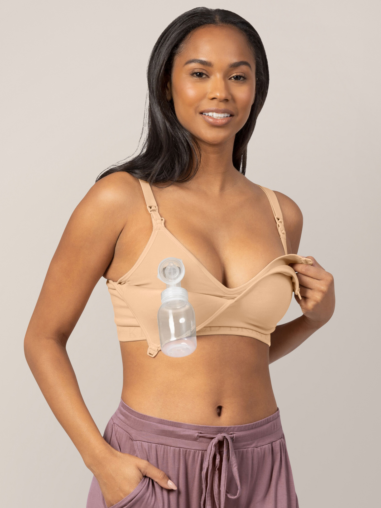 Model hooked to a pump while showing the easy clip down nursing access on the Signature Sublime® Contour Hands-Free Pumping & Nursing Bra in Beige