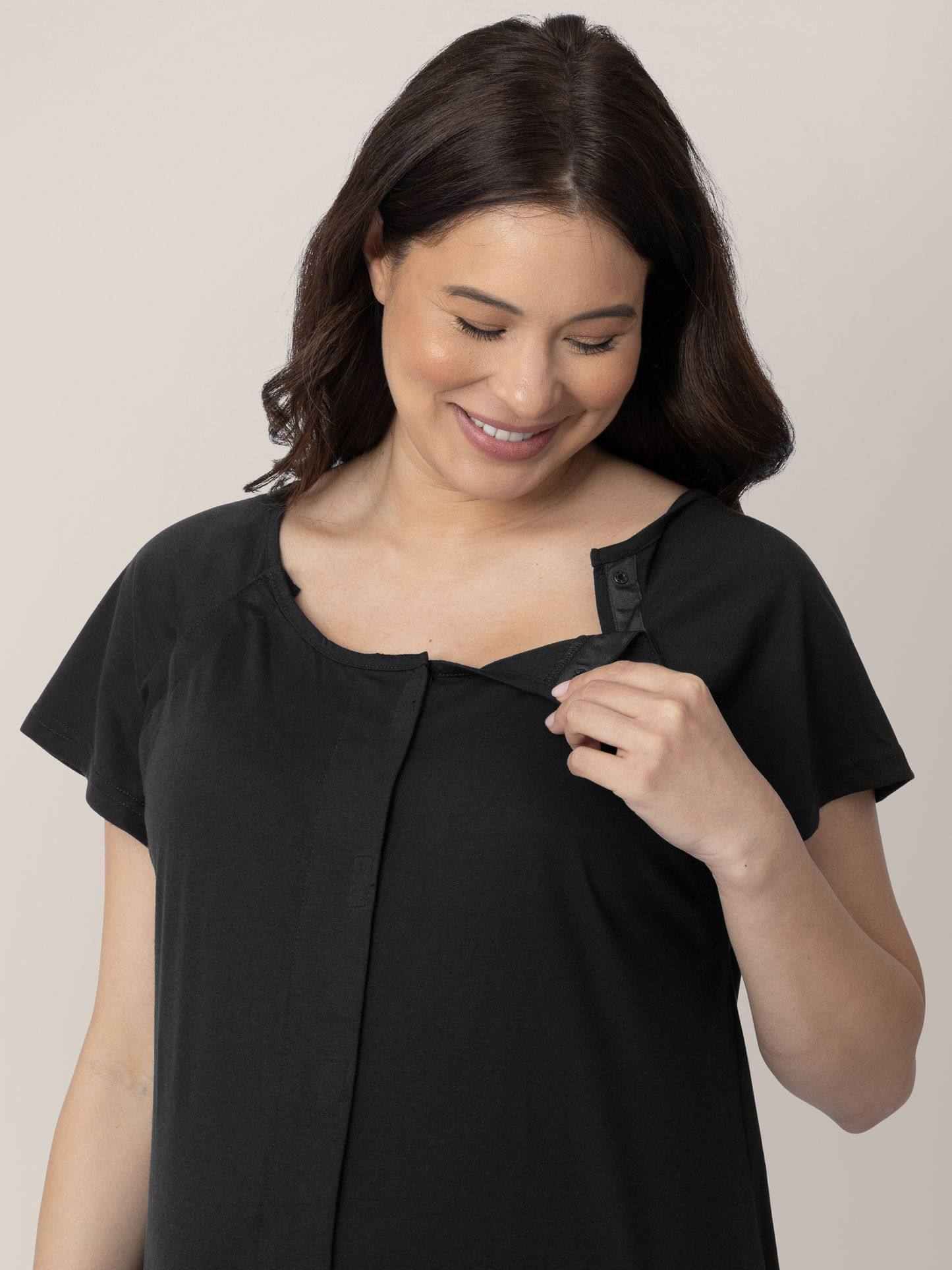 Pregnant model showing the easy clip down nursing and labor access on the Universal Labor & Delivery Gown in Black