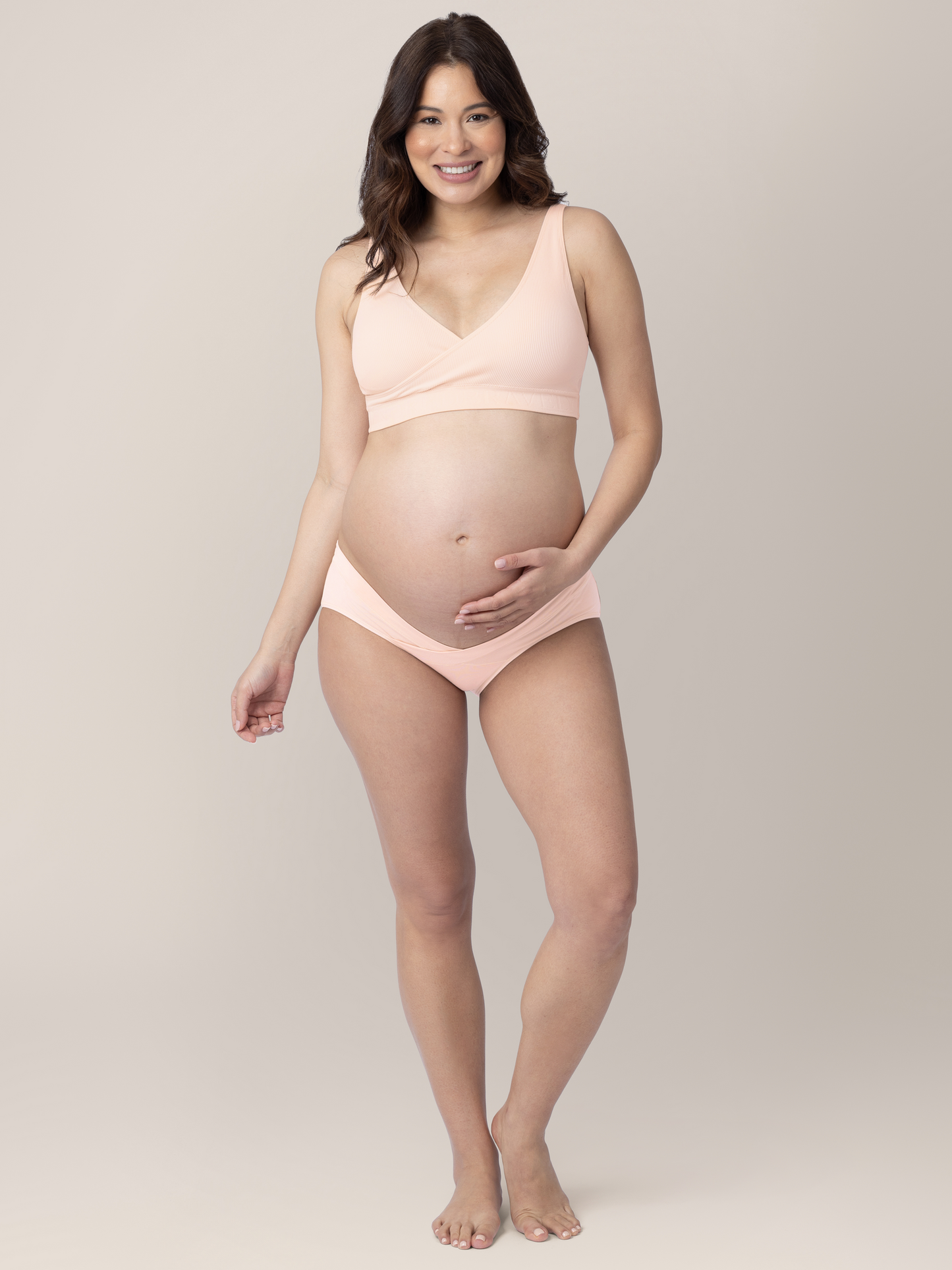 Full body shot of a pregnant model wearing the Under-the-Bump Bikini Underwear in assorted colors 