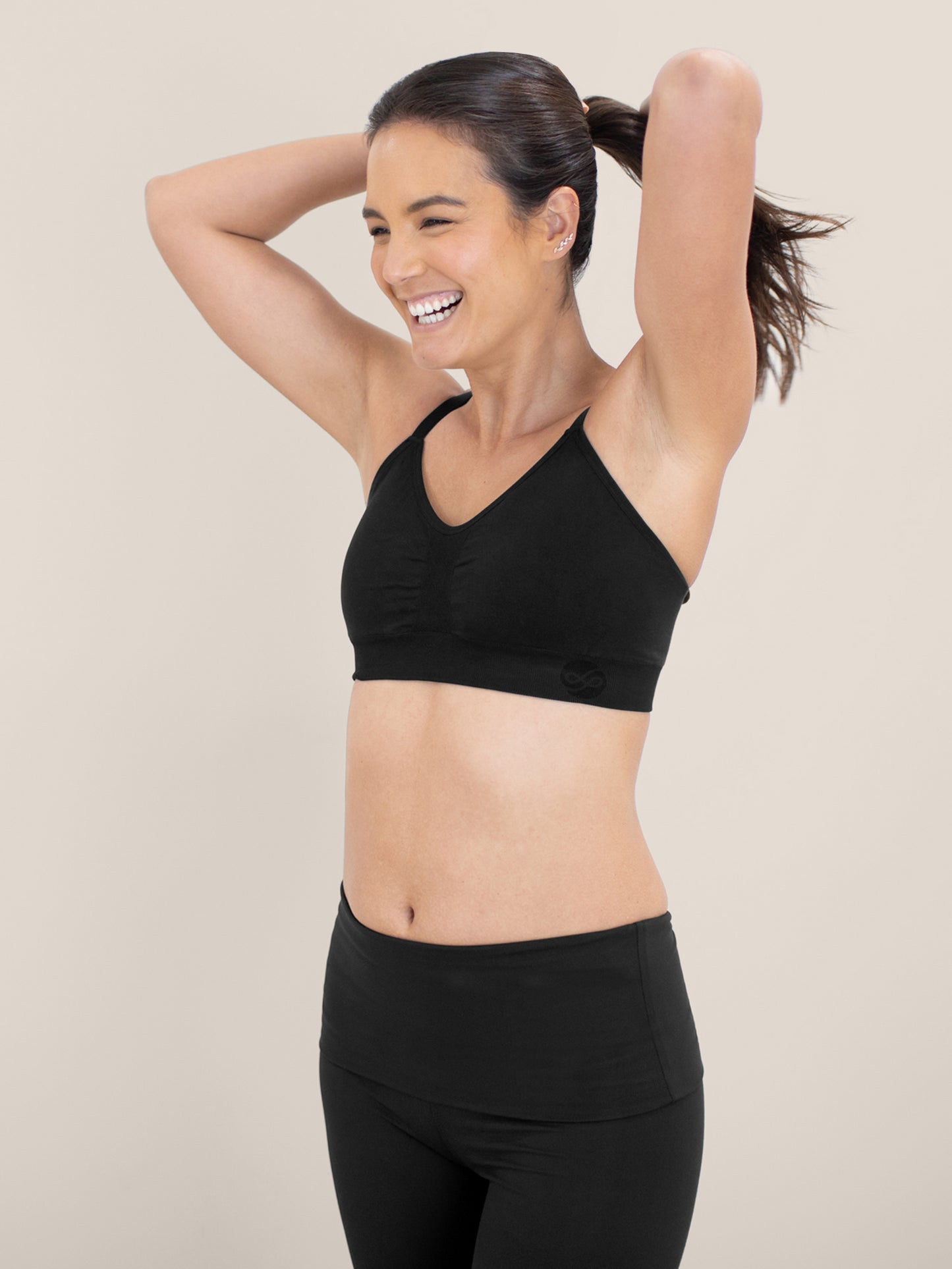 Model with her hands in her ponytail wearing the Diana Sublime® Sports Bra in Black