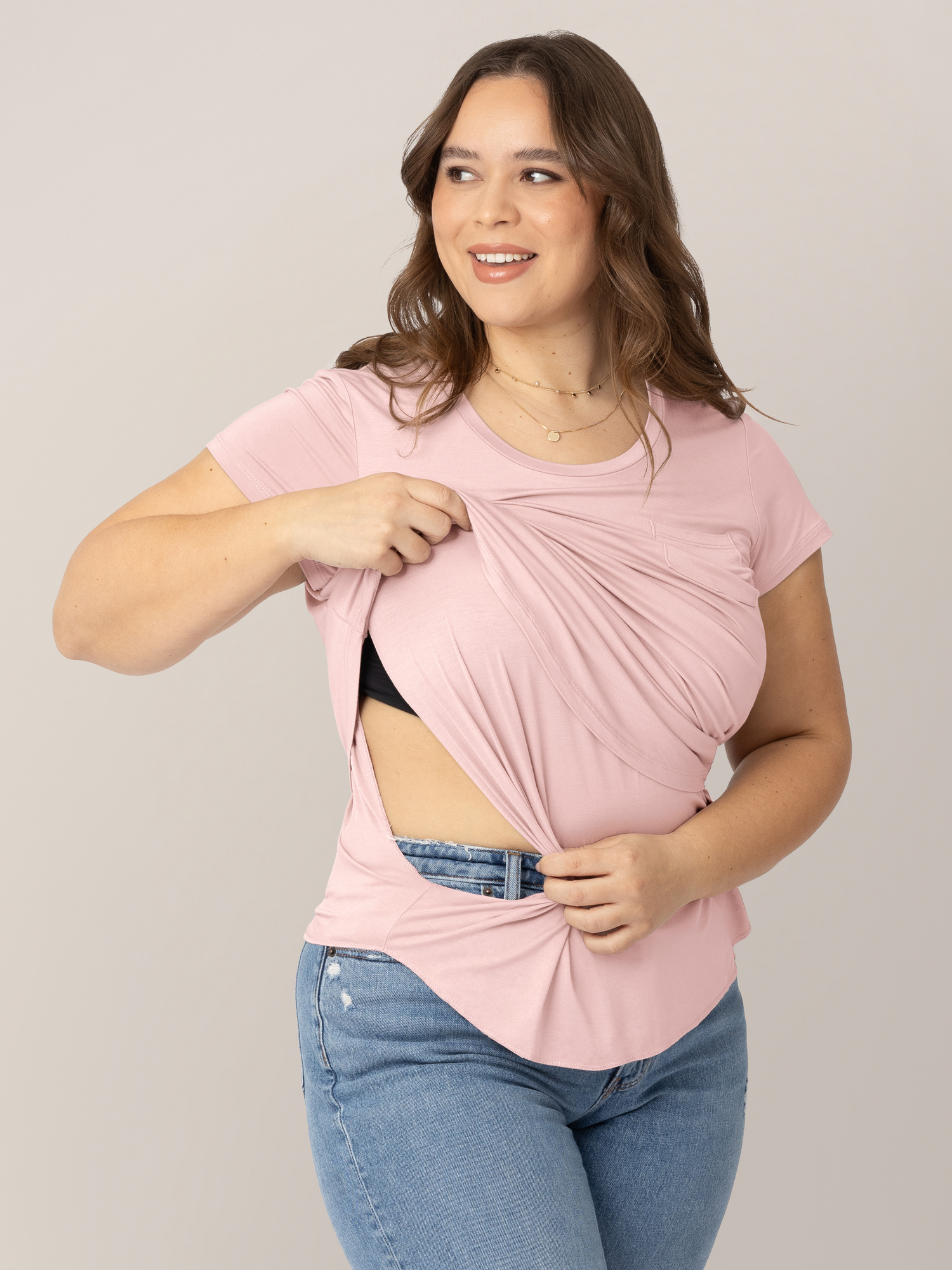 Model holding up the nursing panel on the  Everyday Maternity & Nursing T-shirt in Dusty Pink