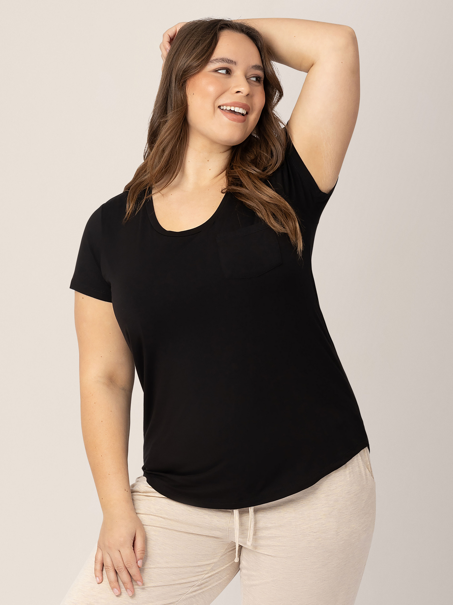 Model wearing the Everyday Maternity & Nursing T-shirt in Black with a pocket. 