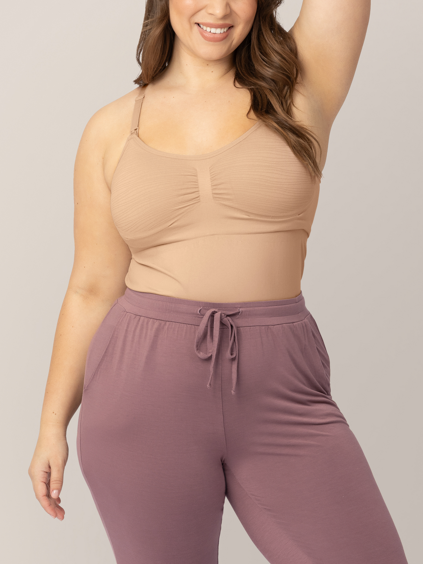 Closeup of the Sublime® Hands-Free Pumping & Nursing Tank in Beige tucked into sweatpants.