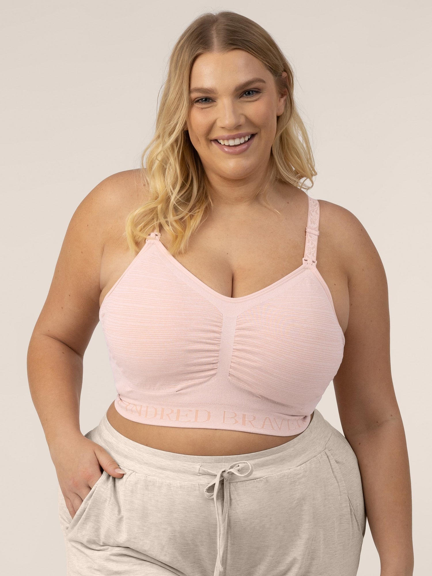 Busty model wearing the Sublime® Hands-Free Pumping & Nursing Bra in Pink Heather