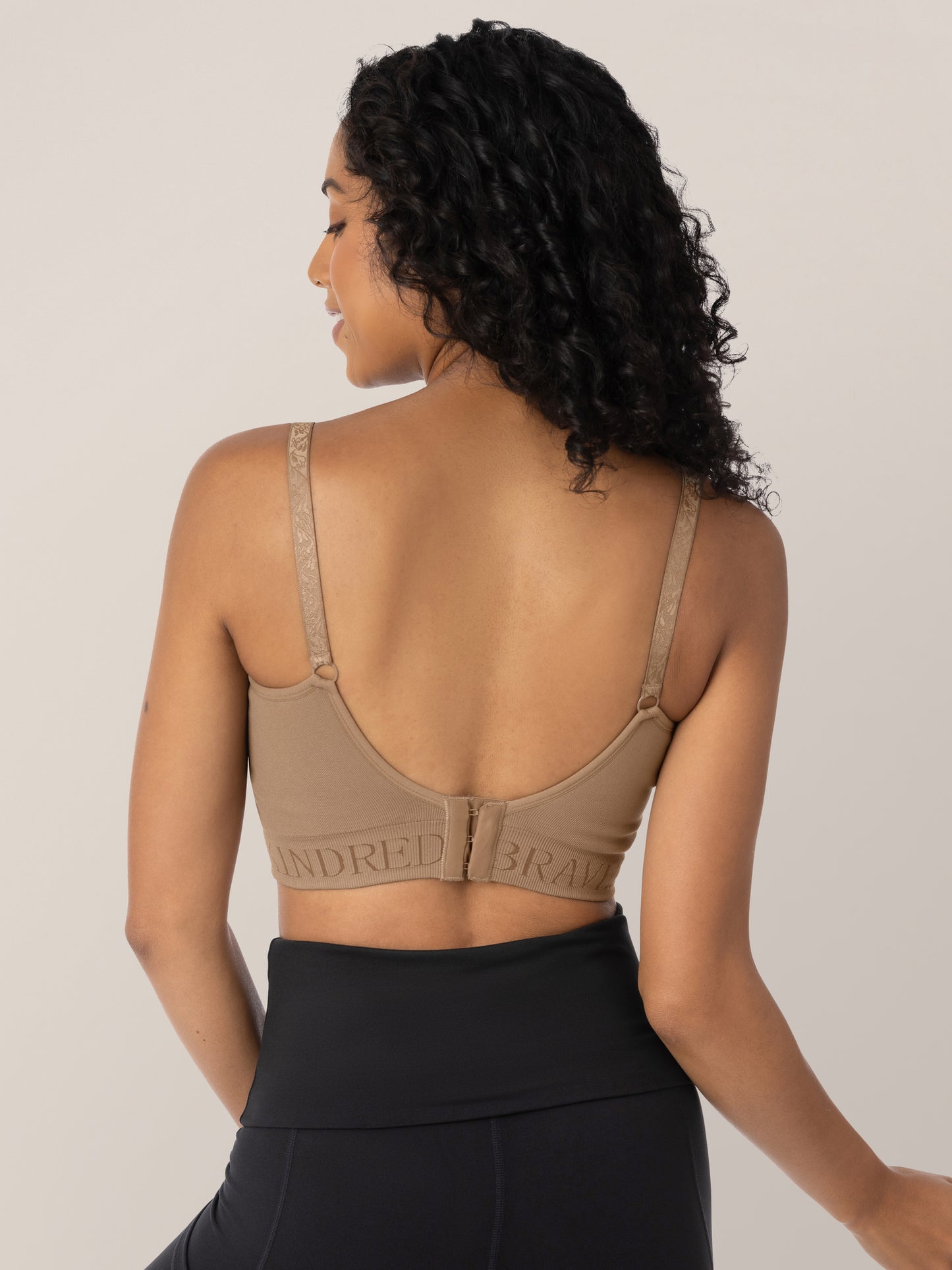 Back view of a model wearing the Sublime® Hands-Free Pumping & Nursing Bra in Latte