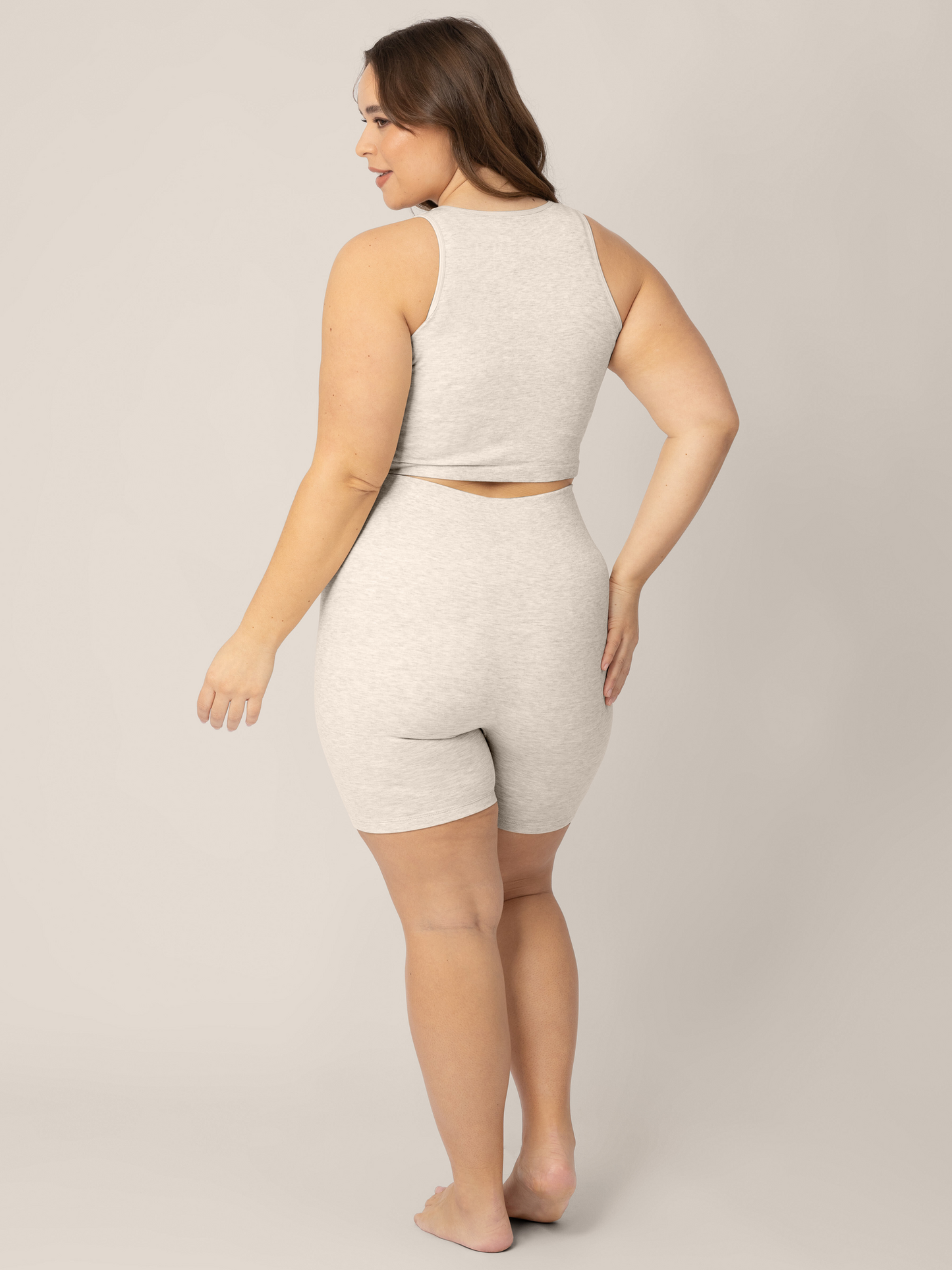 back view of a model wearing the Sublime® Bamboo Maternity & Postpartum Bike Short in Oatmeal Heather, paired with matching Sublime® Bamboo Maternity & Nursing Longline Bra