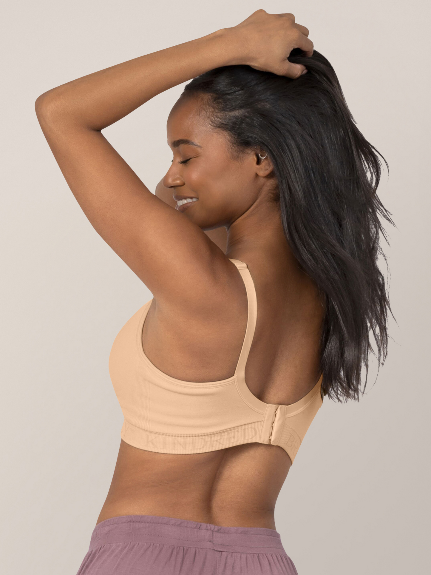 Back of a model wearing the Signature Sublime® Contour Hands-Free Pumping & Nursing Bra in Beige
