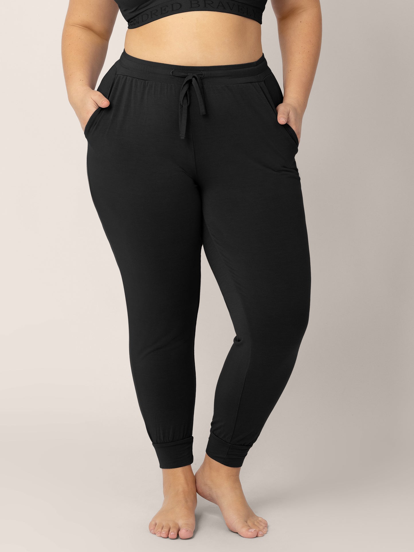 Bottom half of a model wearing the Everyday Lounge Jogger in Black. @model_info:Venezia is 5'6" and wearing an X-Large Regular.