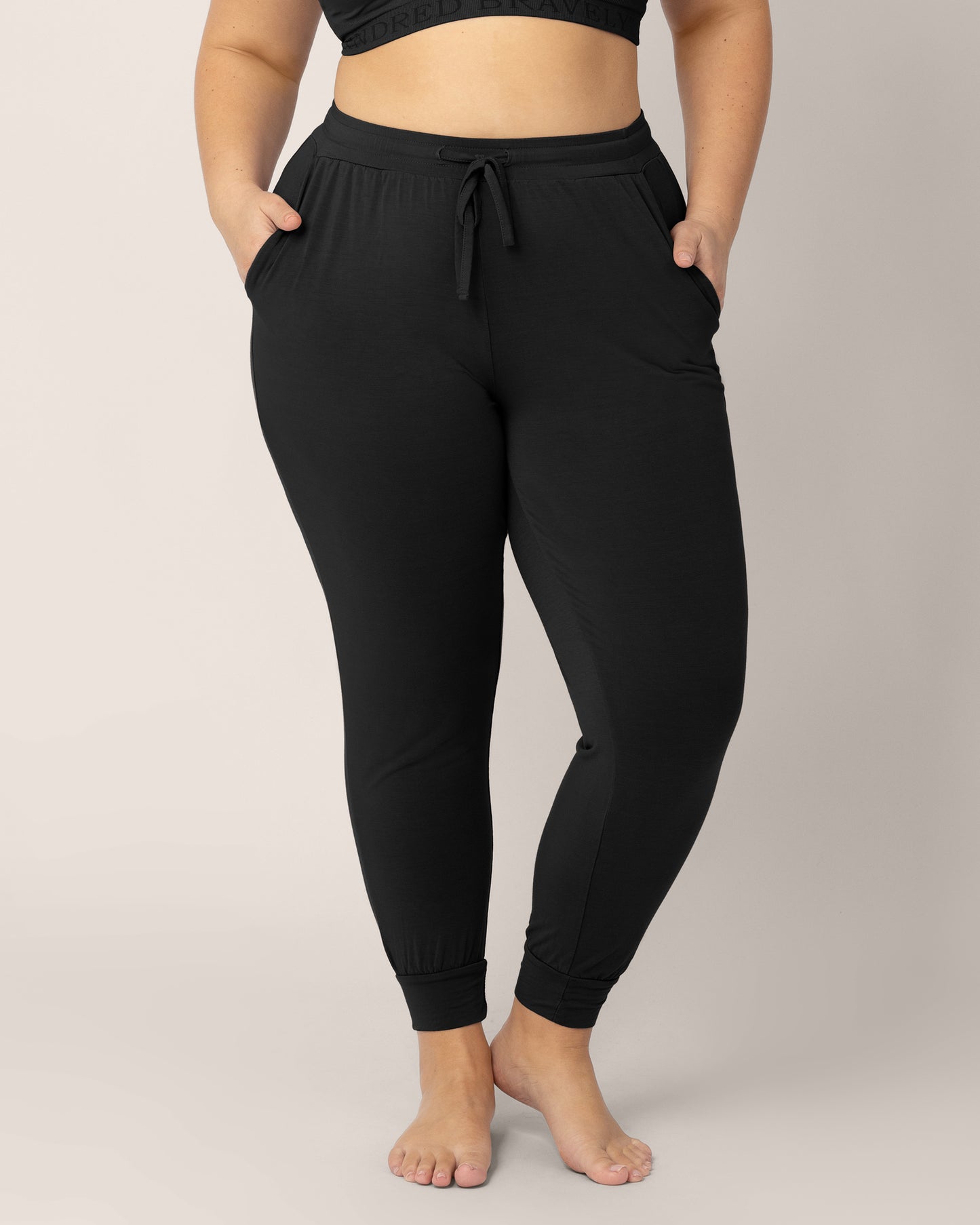 Bottom half of a model wearing the Everyday Lounge Jogger in Black. @model_info:Venezia is 5'6" and wearing an X-Large Regular.