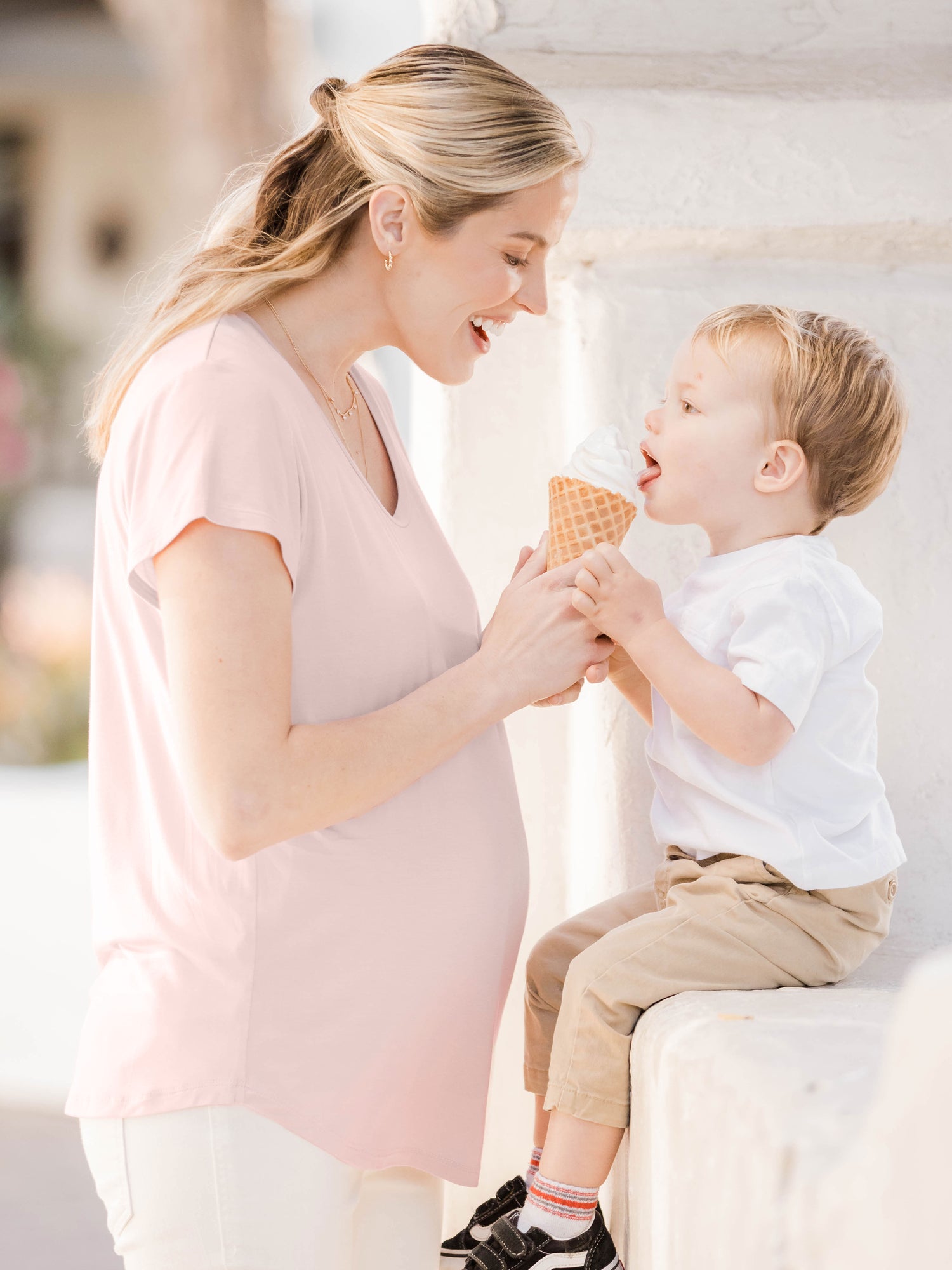 Model wearing the  Everyday Maternity & Nursing T-shirt in Dusty Pink feeding her baby icecream. @model_info:Mia is wearing a Small.